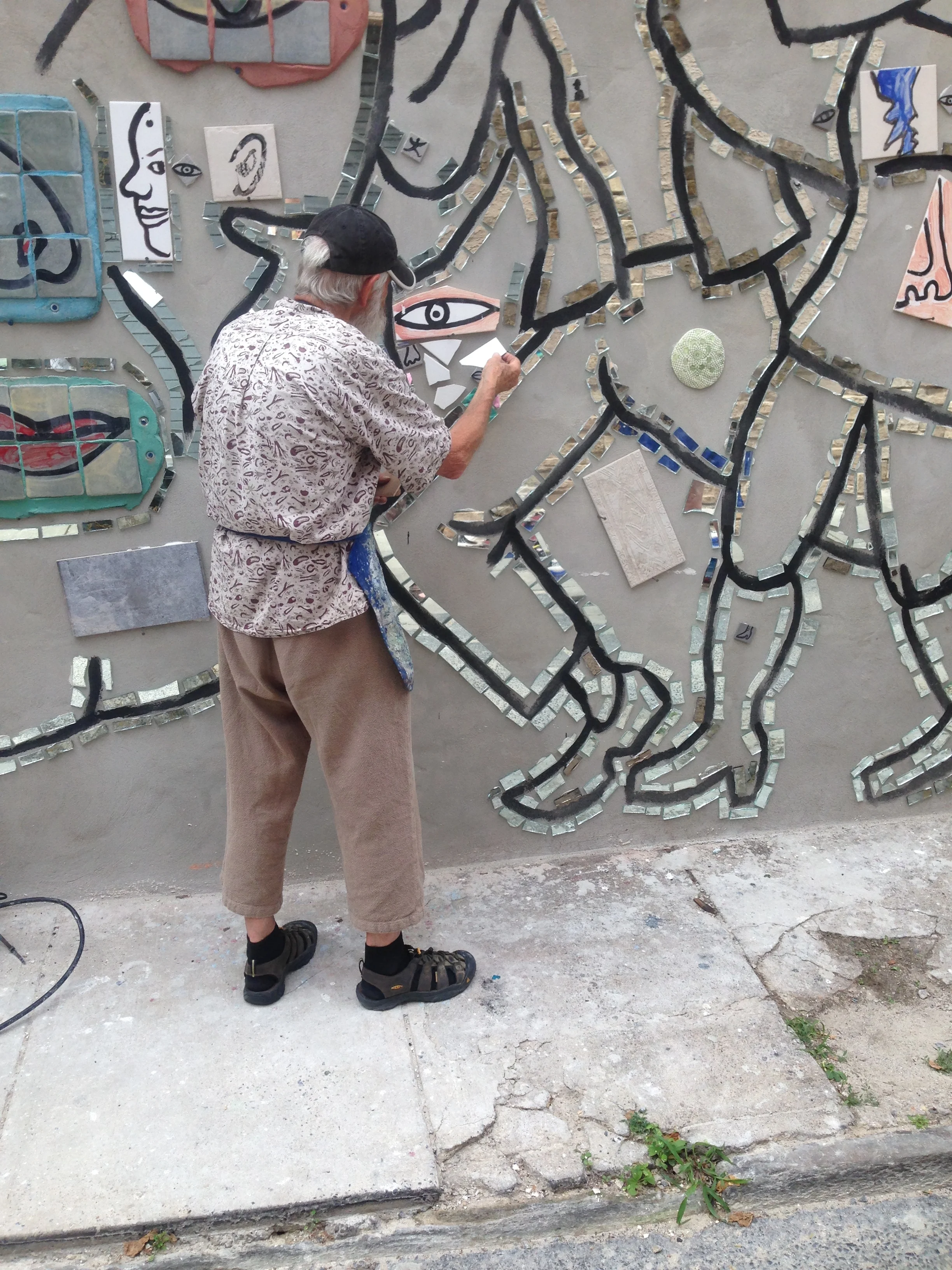 Zagar showing us how to apply mosaic tile. 