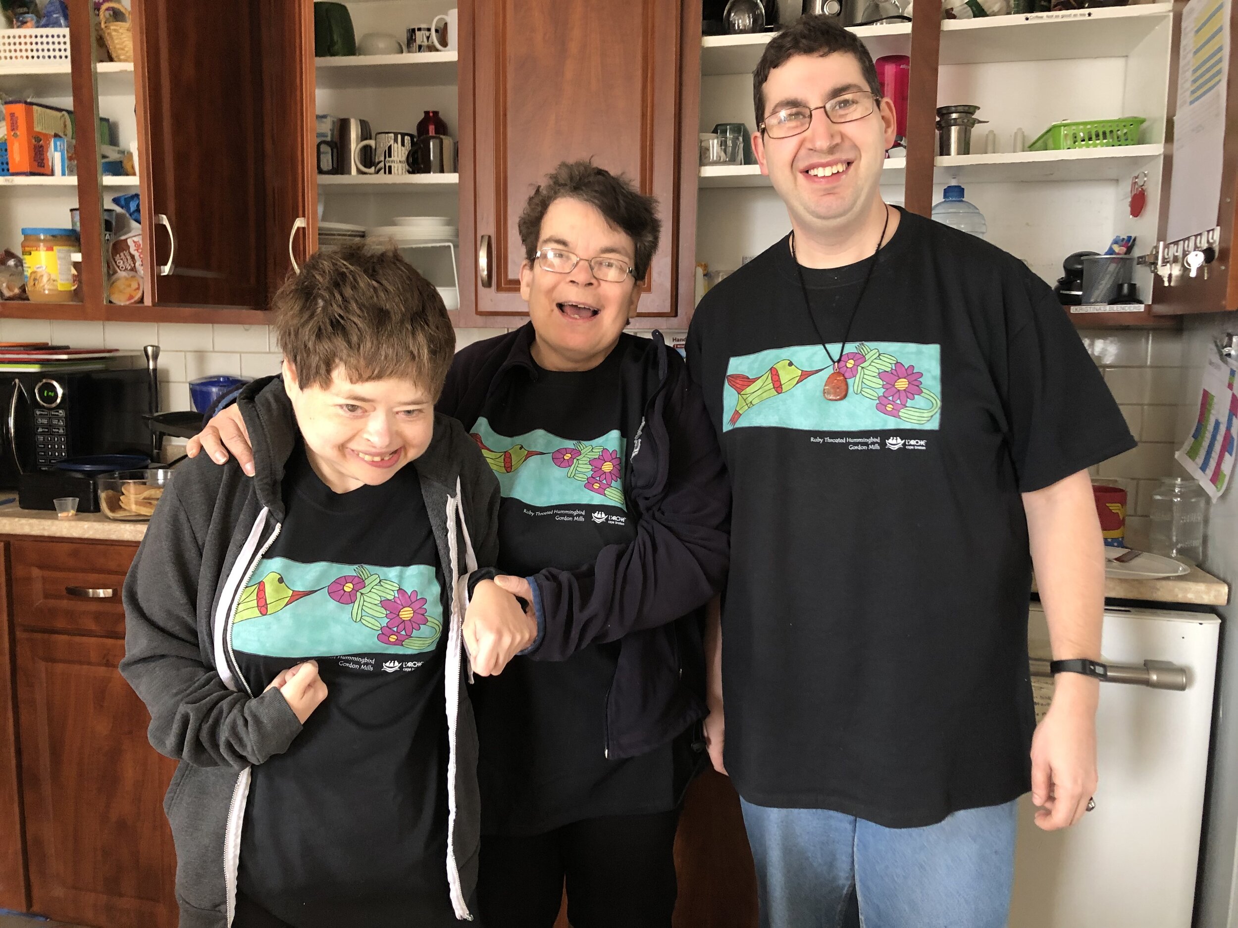Kristina (left), Debbie (centre), and Stéphane (right) smile in the kitchen. Kristina passed away peacefully in January 2021.