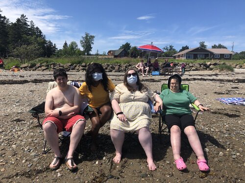 Left to right: Patrick, Mansa, Vic and Debbie enjoy a beach day last summer.
