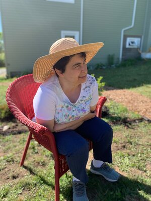 Sarah Keyes enjoys a a moment’s rest, thanks to generous donors who gifted us these beautiful garden chairs!