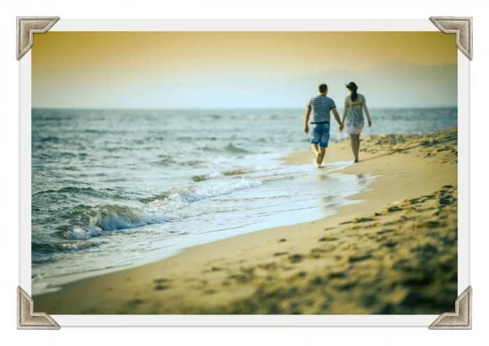 Couple enjoying a warm summer evening together, smiling and holding hands
