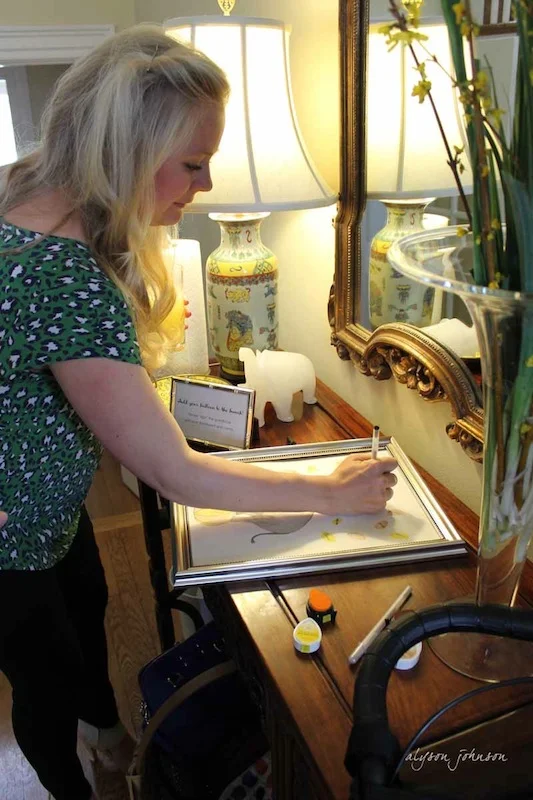 Guests stamp the paper with their thumb and sign it with the pen.  Hopefully your beautiful guests are forgiving if you put their picture on the internet.  :)