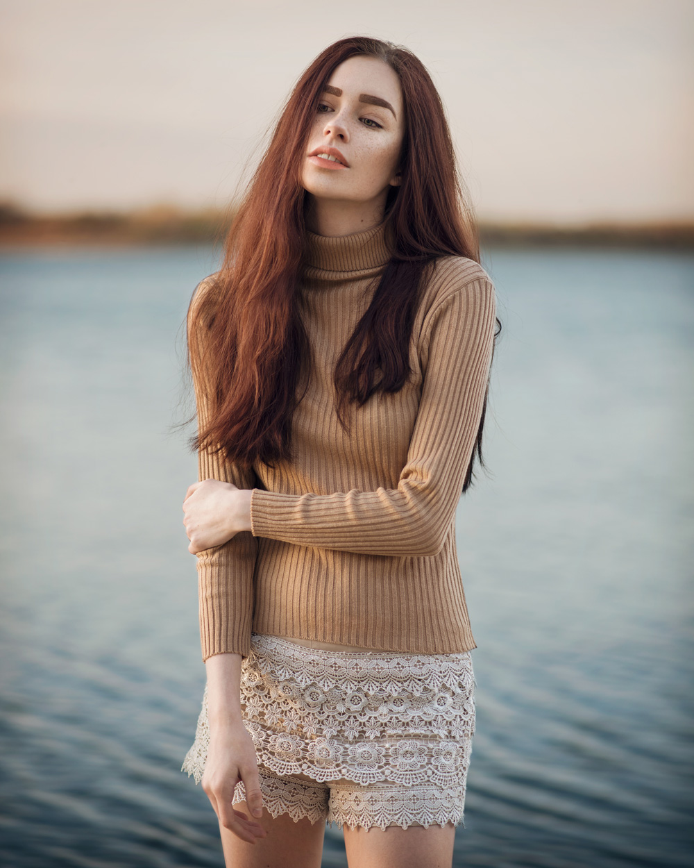Calgary fashion model standing in front of water