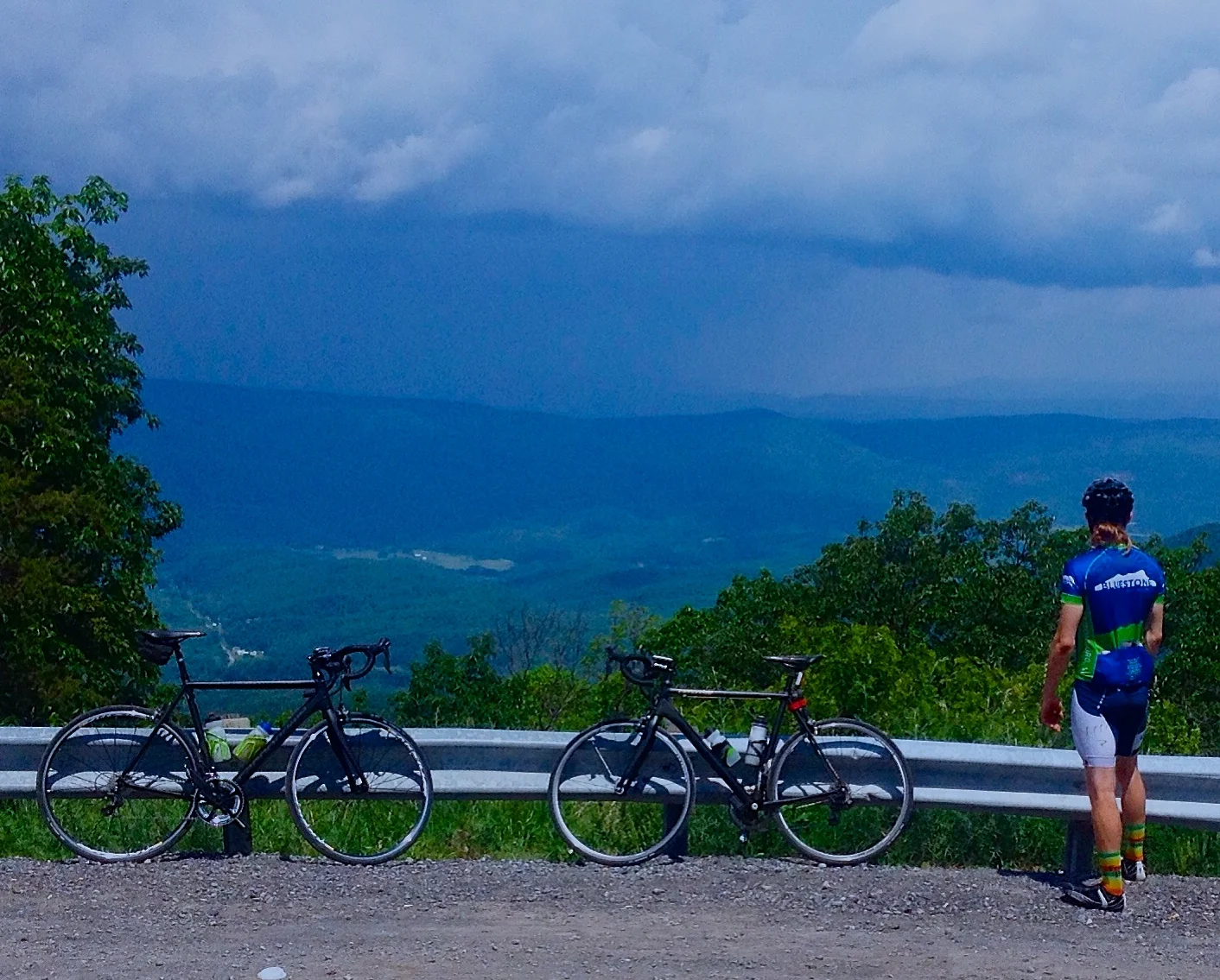 David Taylor at the top of the climb on the state line looking west at the rains headed our way.