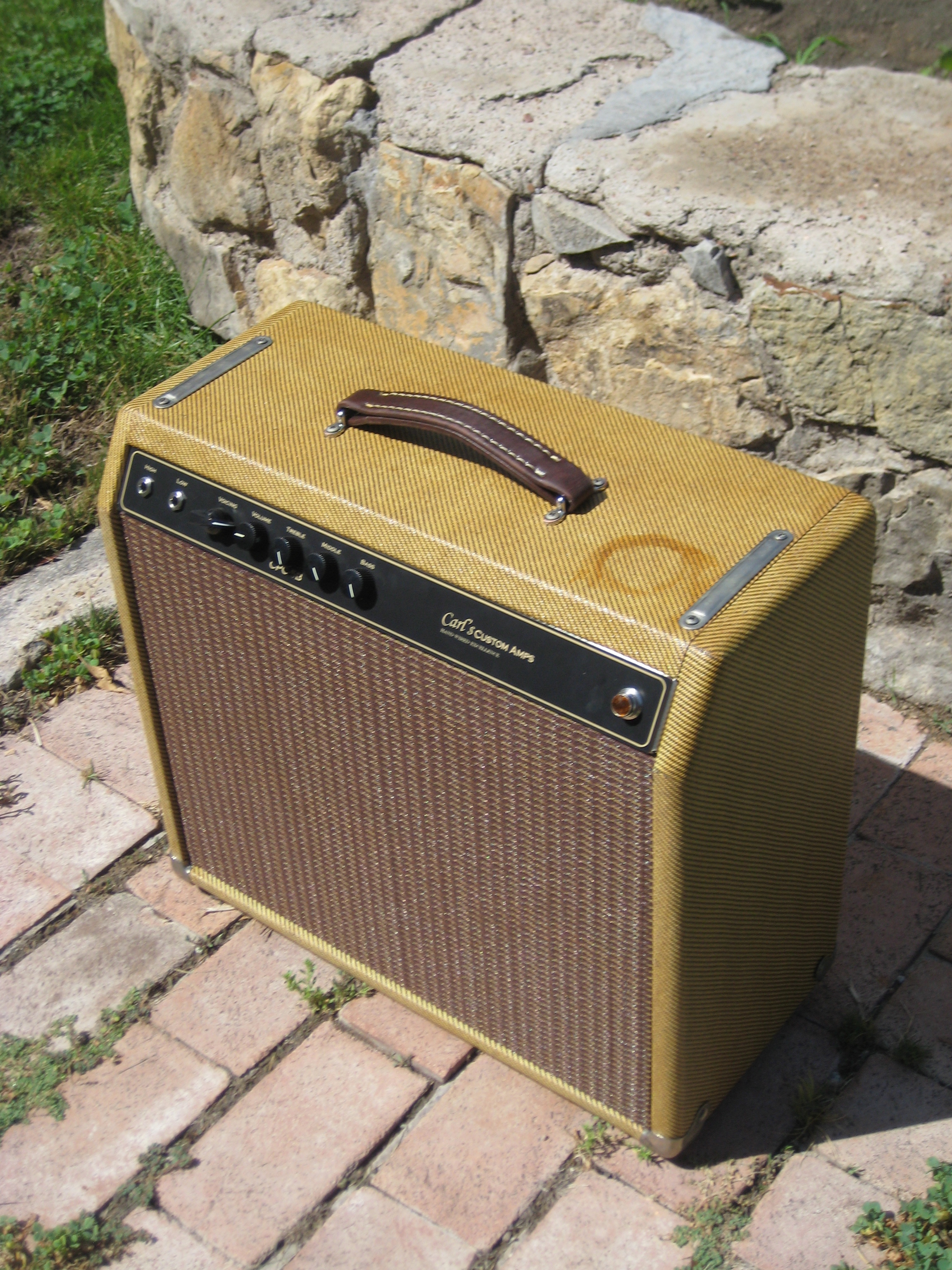 This custom build was really neat. The customer wanted the amp to be aged with a beer ring! It's got modified version of the Blackface Champ (more bite!) in there with a mids control and three way tone switch.