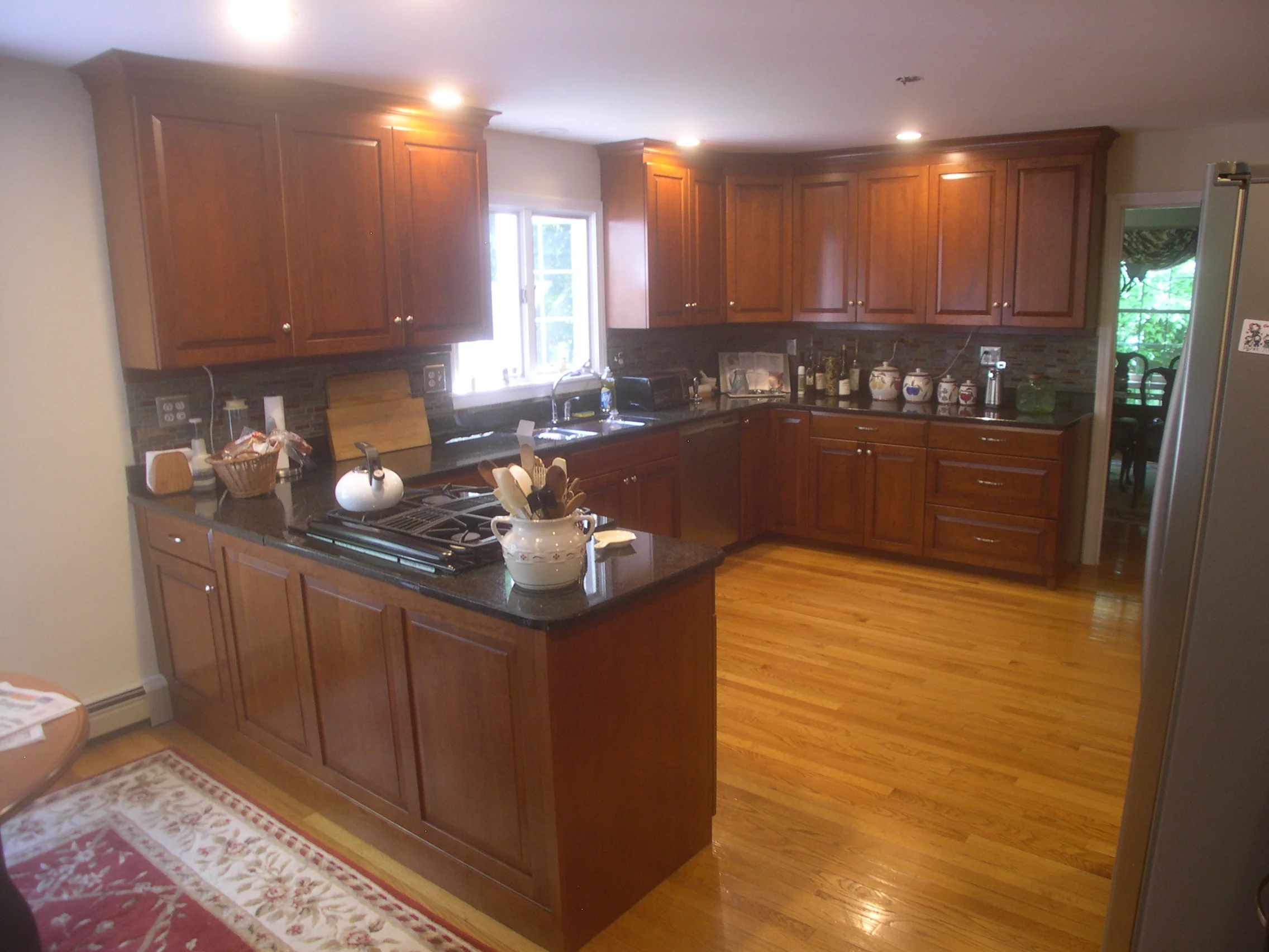 Cherry Kitchen built without moving existing granite countertops