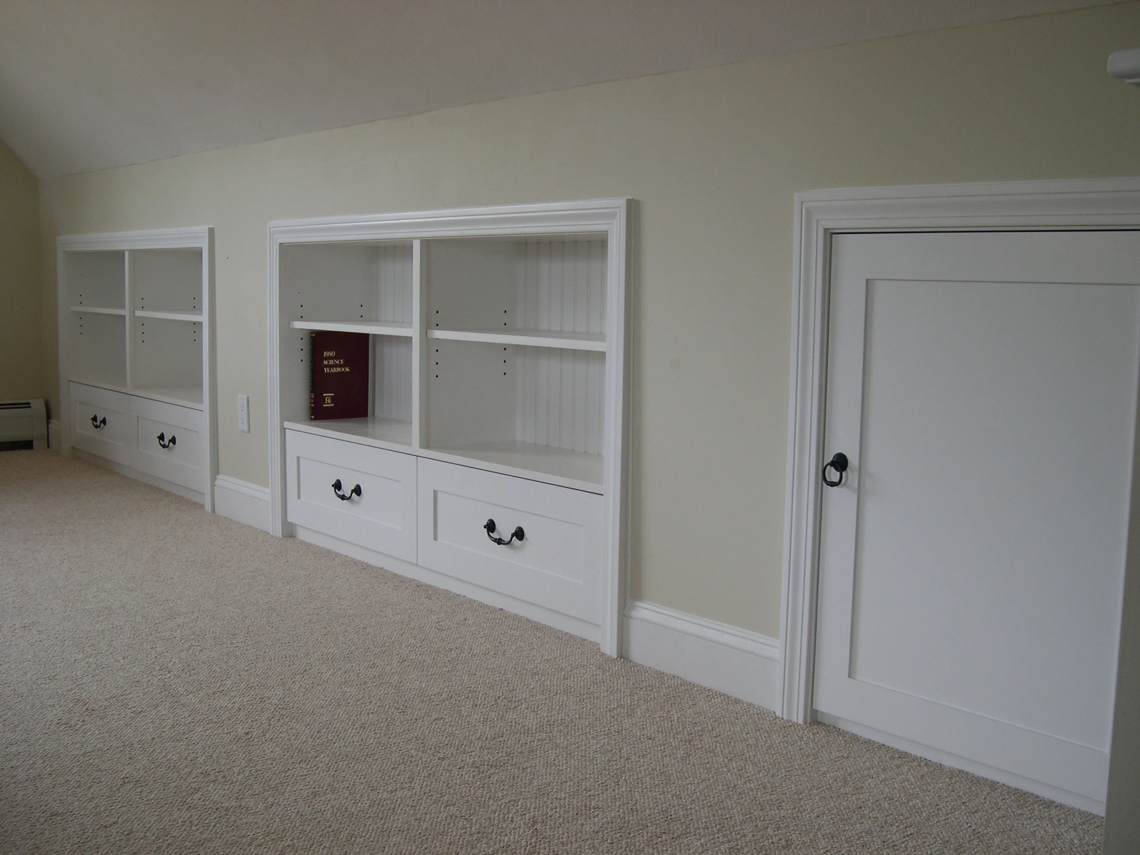 Knee wall bookcases with deep drawers