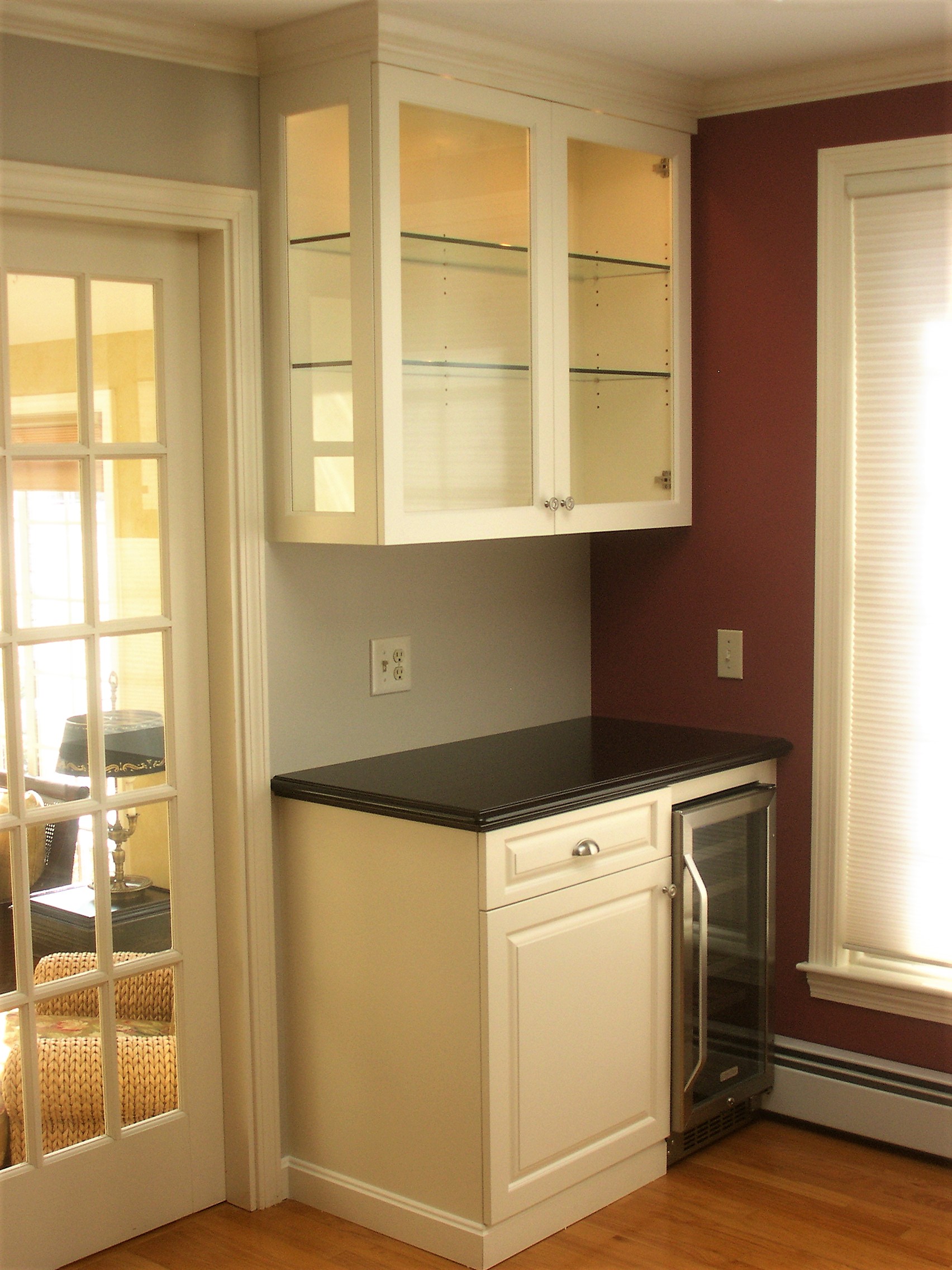Display case with corner cabinet and mini refrigerator