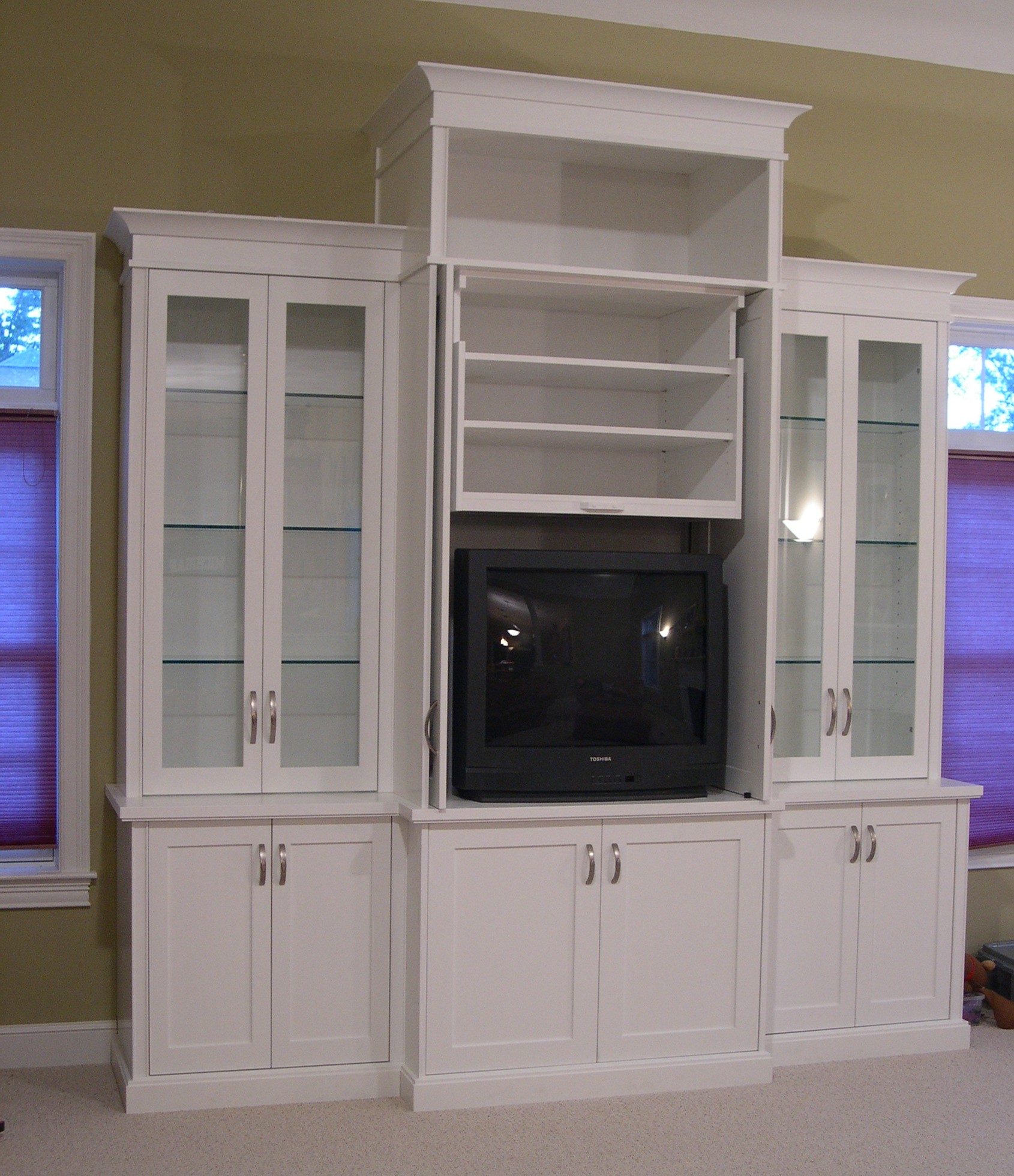 Open white television unit with display cases and under mount lighting