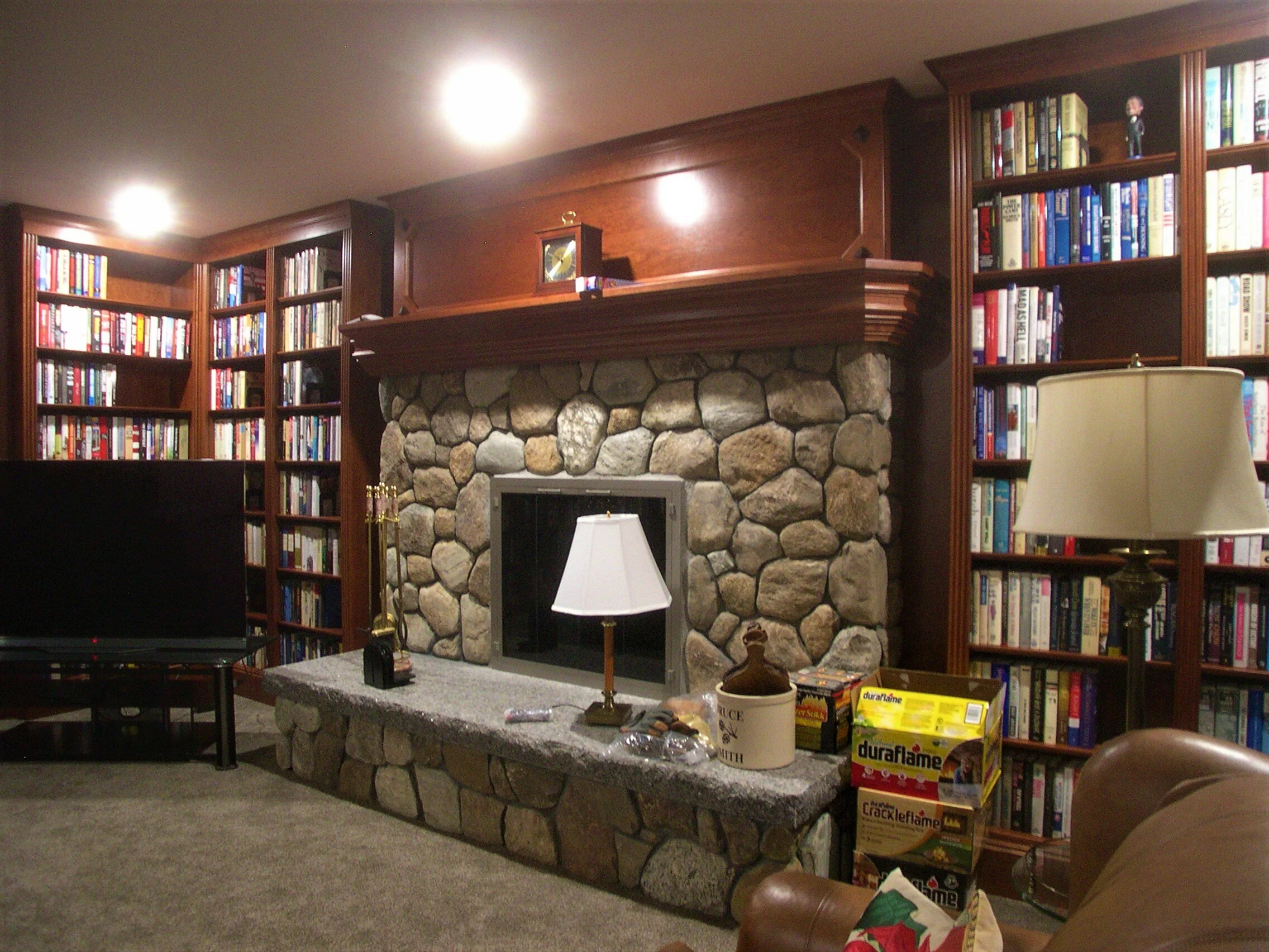   Downstairs library bookcases, stained cherry with clear lacquer finish - fireplace with mantle  