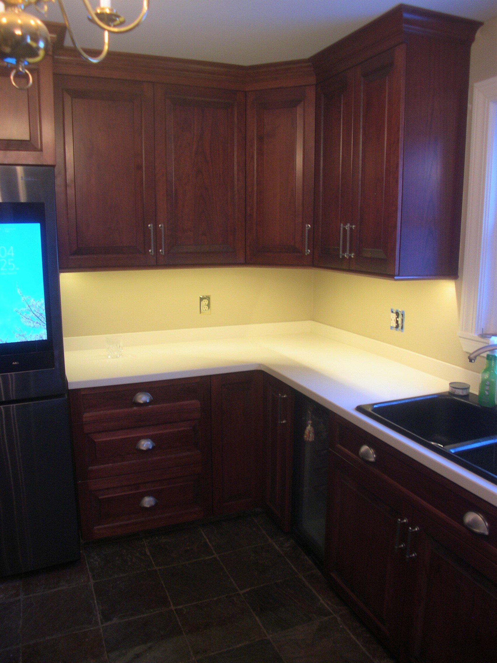   Cherry stained kitchen with raised panels, sprayed with clear lacquer - corner  