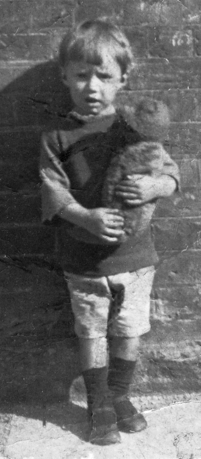 Three-year-old Des Drew clutching his precious teddy bear.