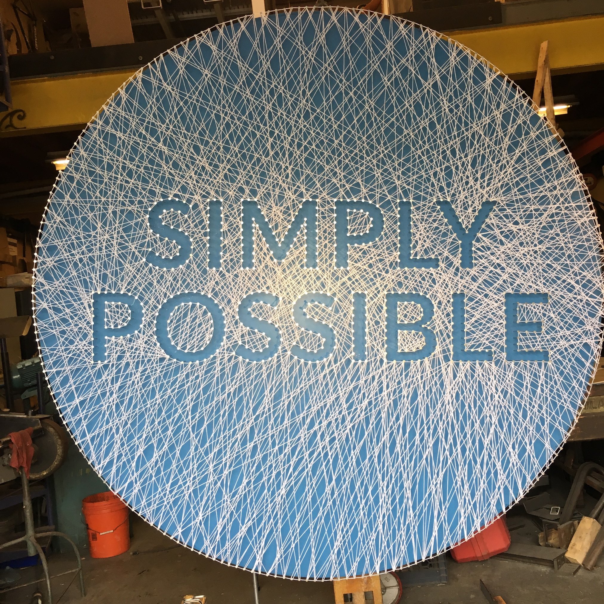 Log Me In Headquarters, Boston, MA |  "Simply Possible" | 2019 | String, Wood, Paint, Nails | 15’ Diameter


