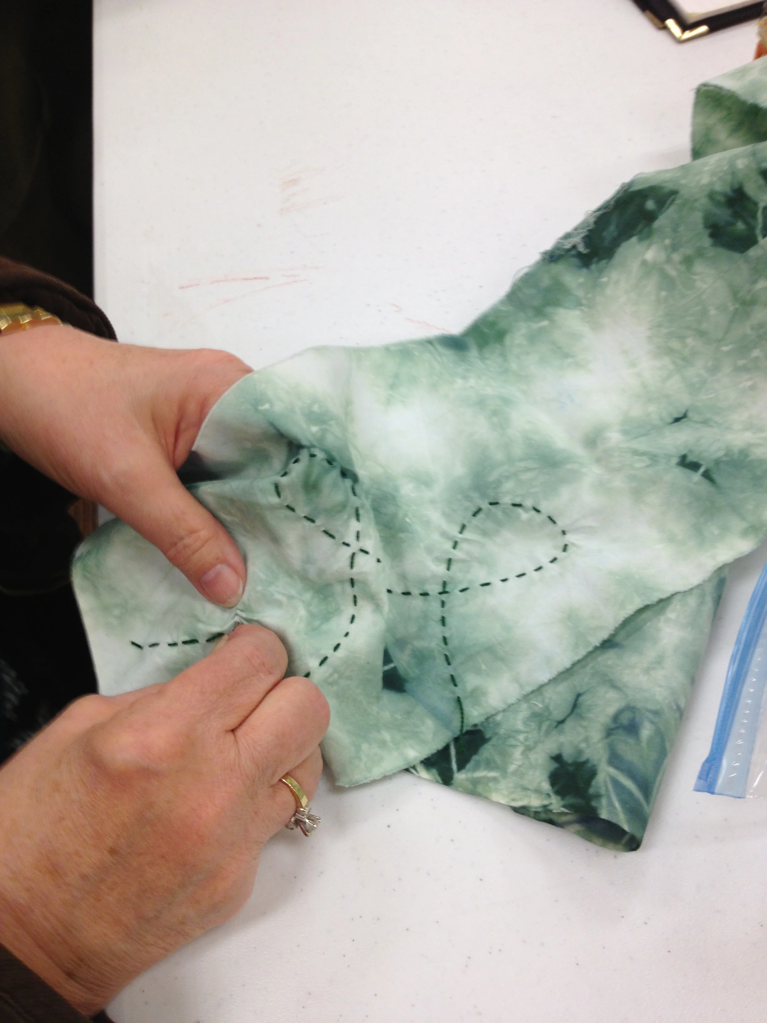 Using running stitches to create line on fabric