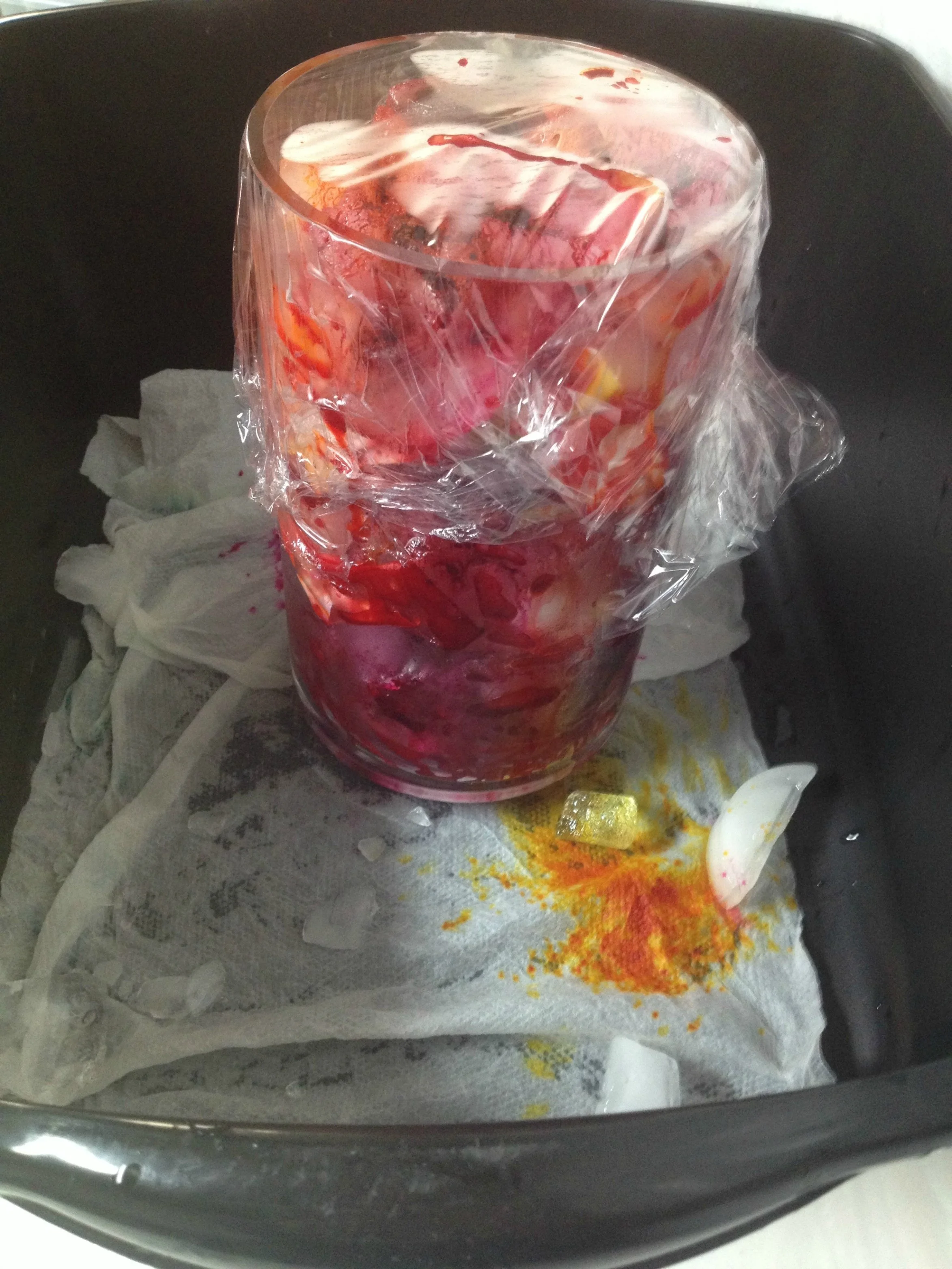 Ice-Dyeing Parfait--three fabrics each layered with ice and dye. It's in a bucket to catch any possible spill-over as ice melts.