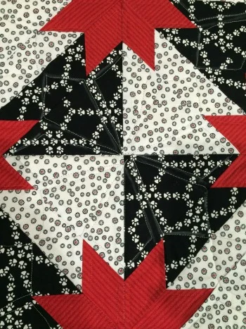 Quilted--you can see the chalk lines and stitching on the black but the thread blends on the white and red.