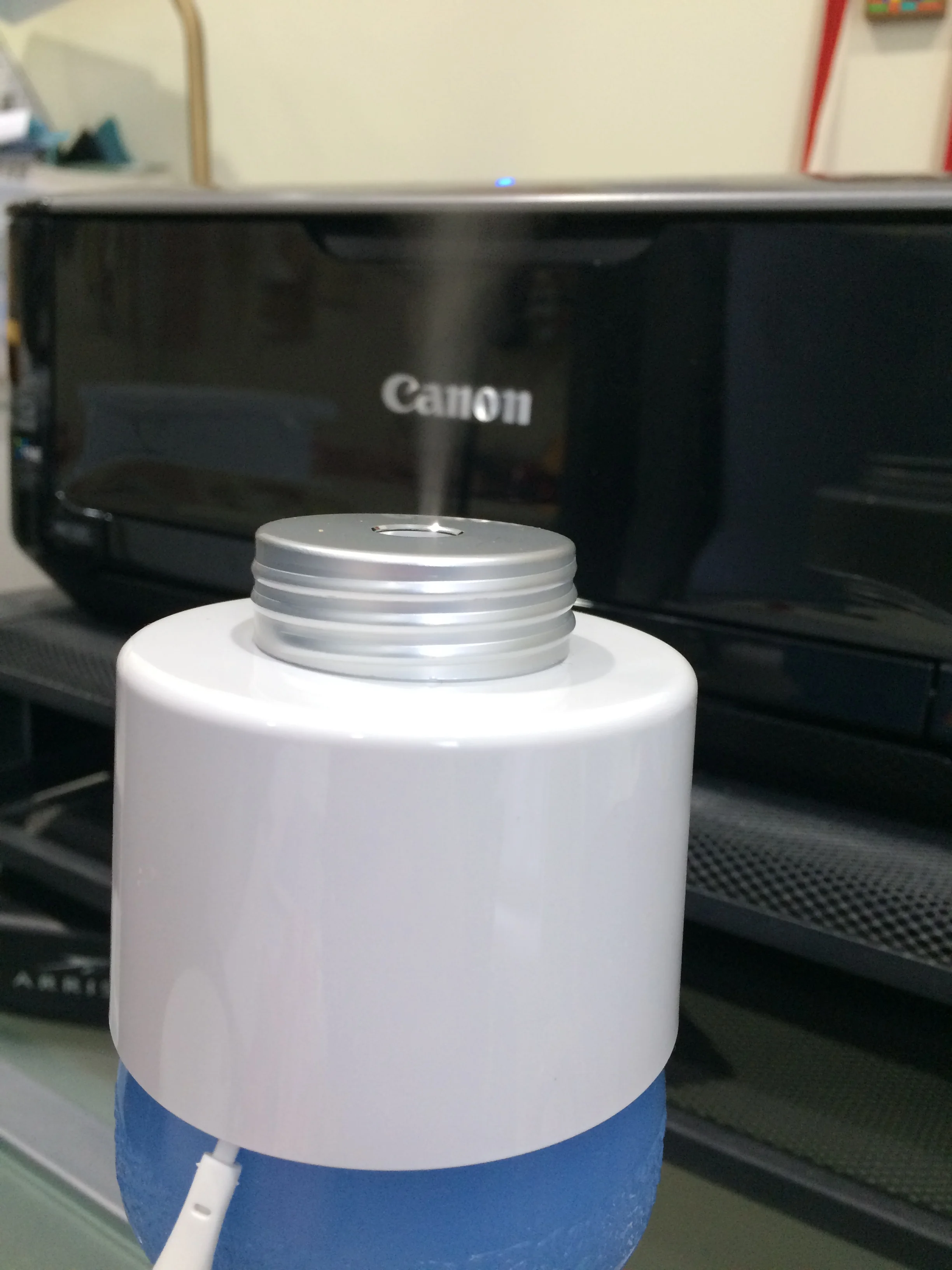 The portable humidifier attached to the top of my water bottle, steaming away.