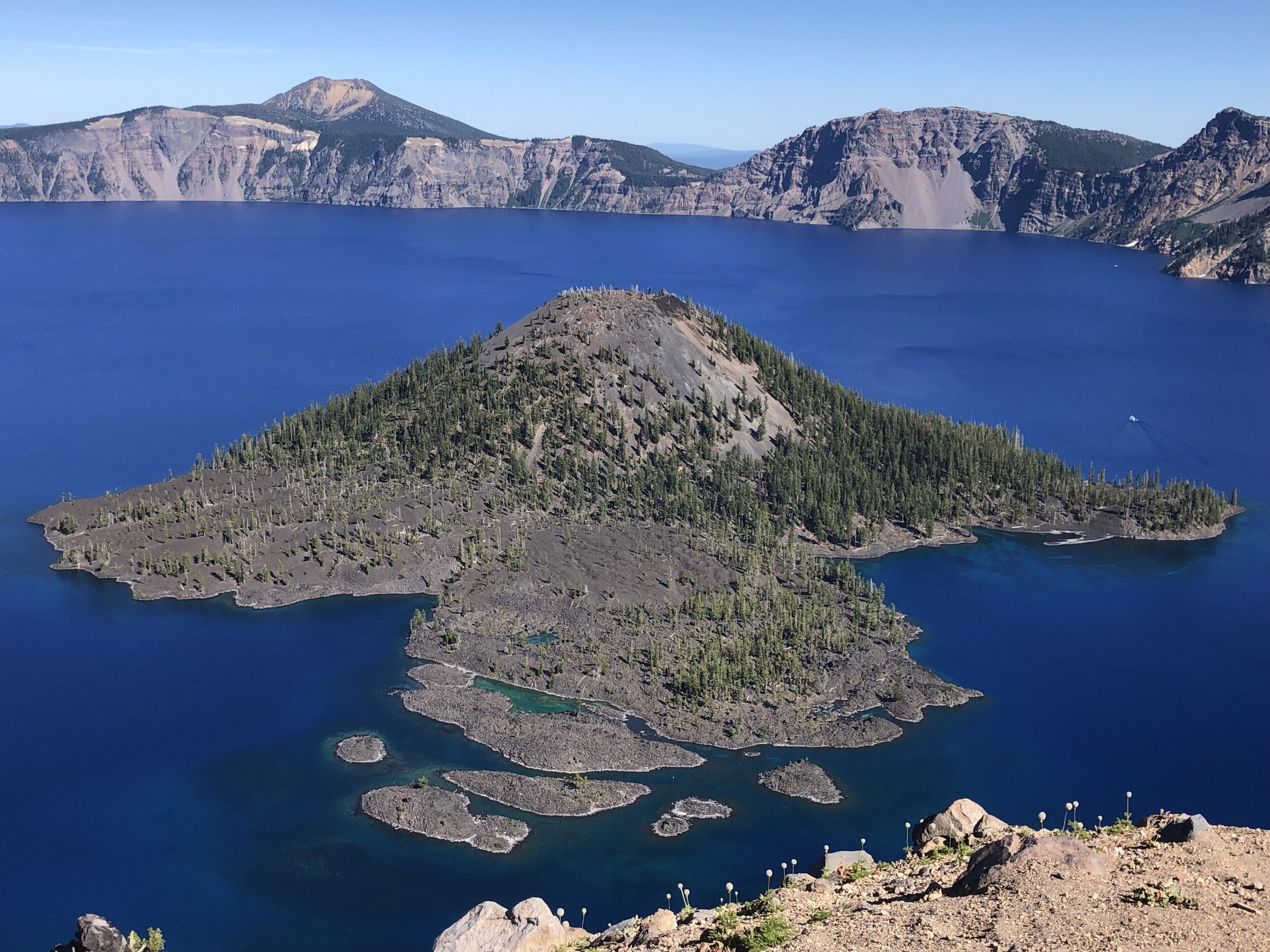 At Crater Lake National Park a deep freshwater lake lies within the original volcano; a cinder cone rises from the depths.