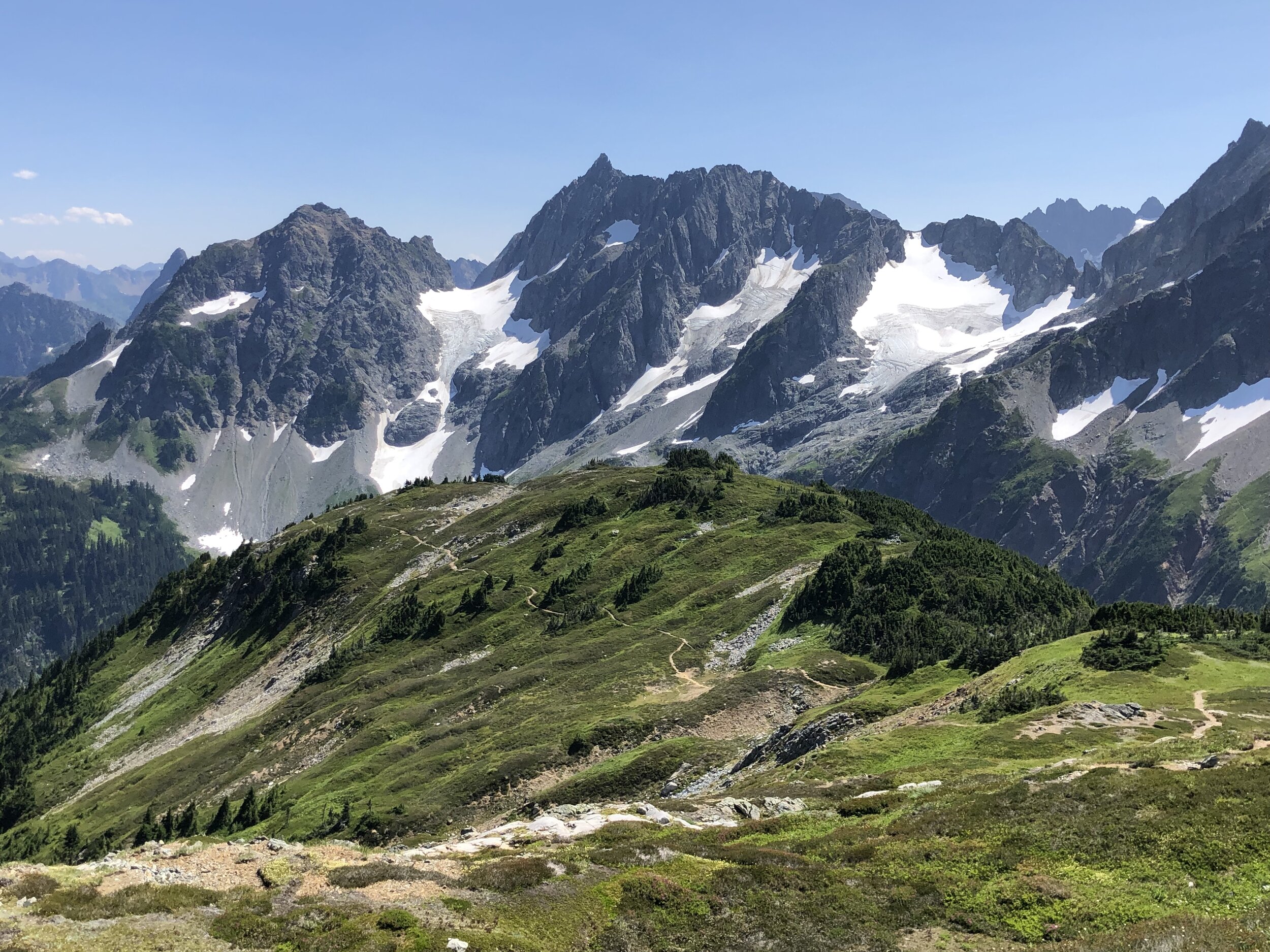 The trail along Sahale Arm makes its way toward its namesake glacier in North Cascades National Park; note the hanging glaciers on the surrounding mountains.