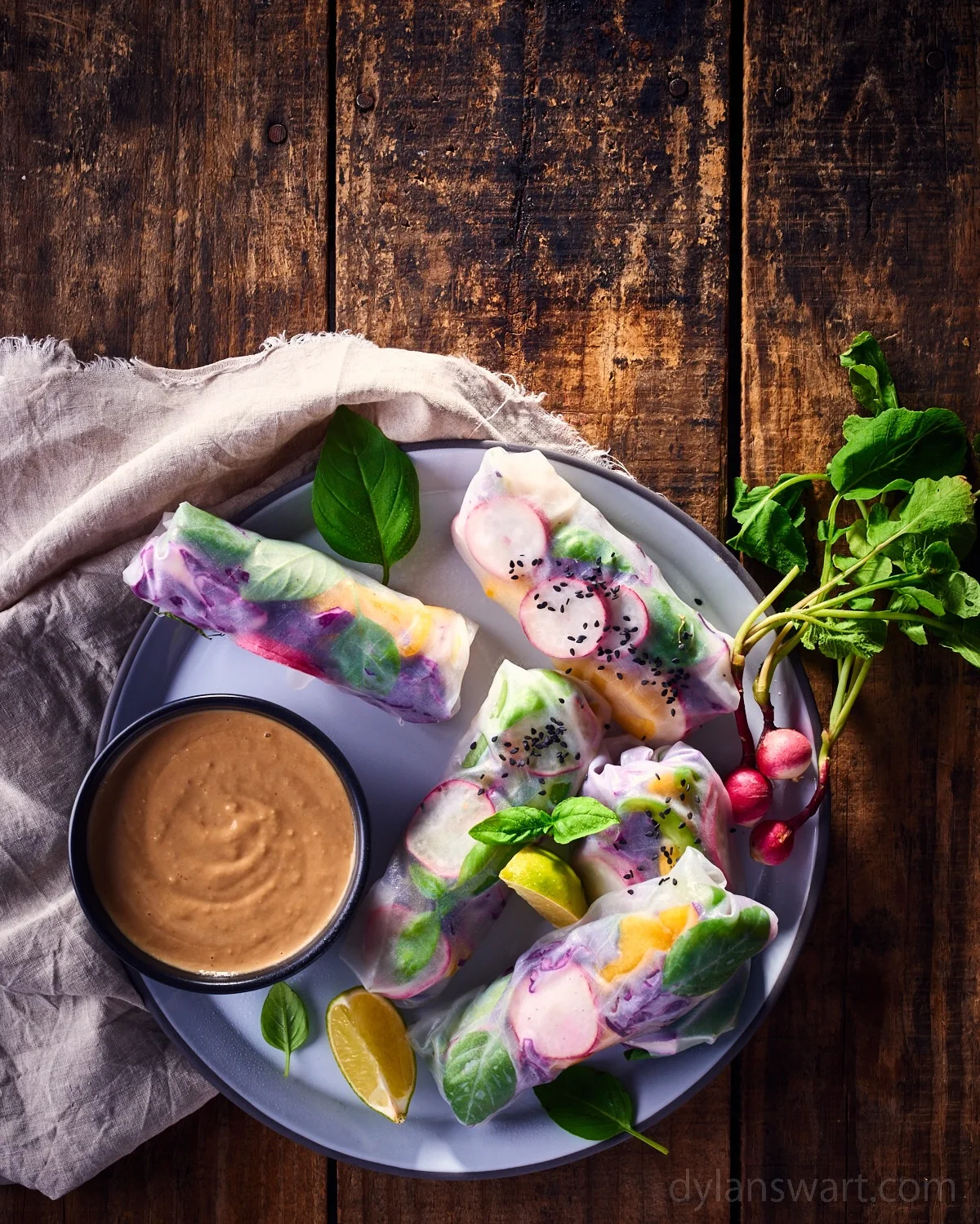 Radish Vietnamese spring rolls served with a nut butter sauce.
