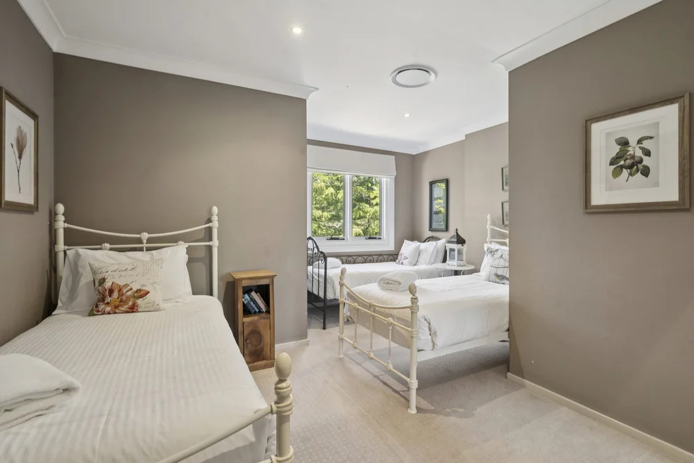 Bedroom 6 with white iron single beds