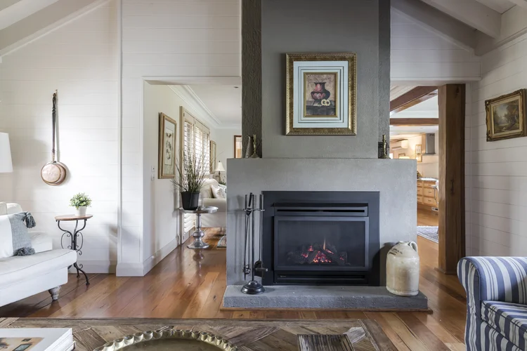 Gas fireplace in the stone chimney breast between the lounges
