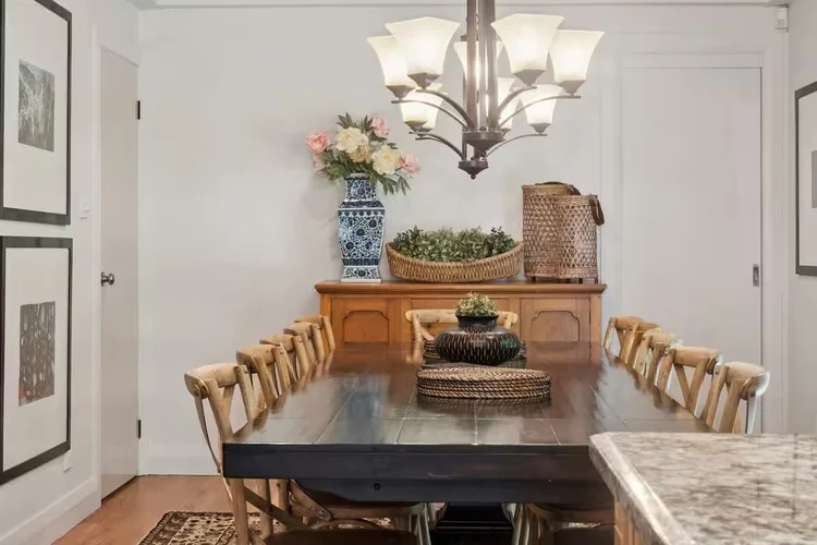 Dining room with a long timber table and chandelier