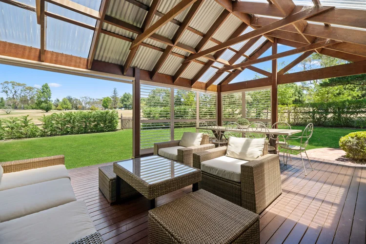 Covered loggia seating looking out across the garden