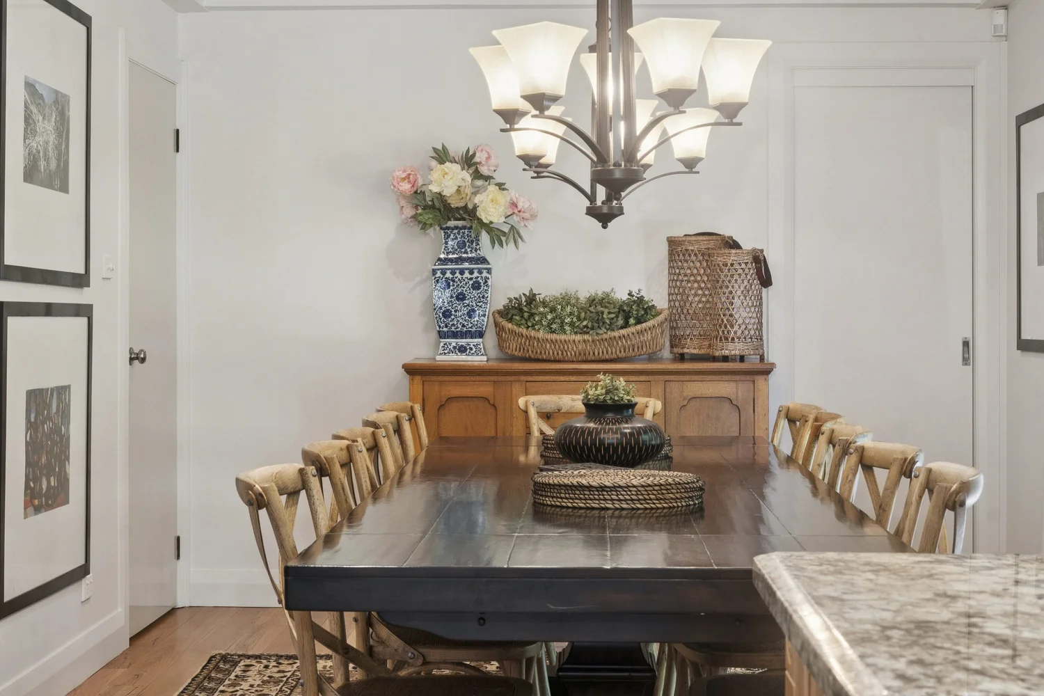 Dining table set beneath a chandelier at Stonelinks