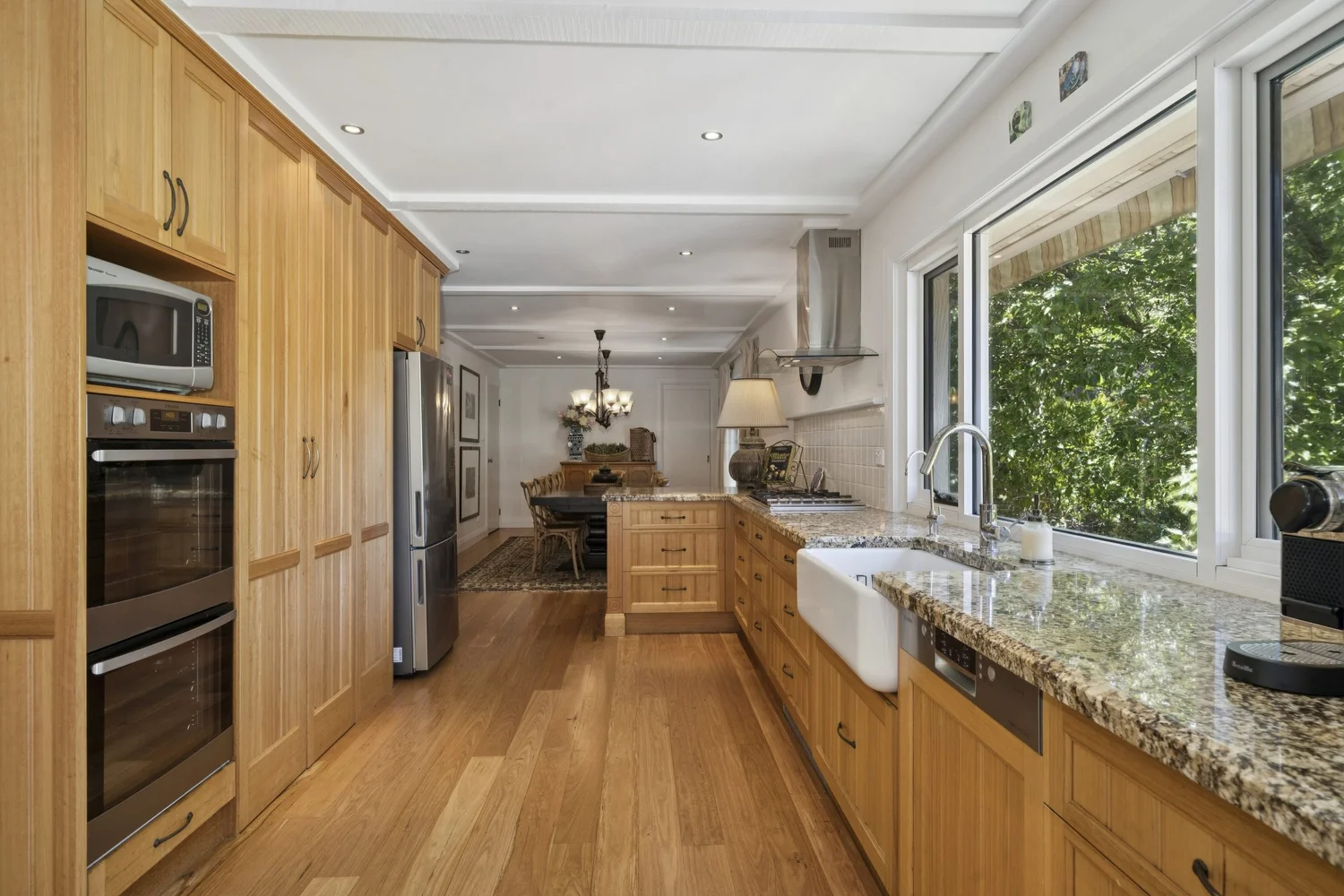 Kitchen with timber cabinetry and double wall ovens