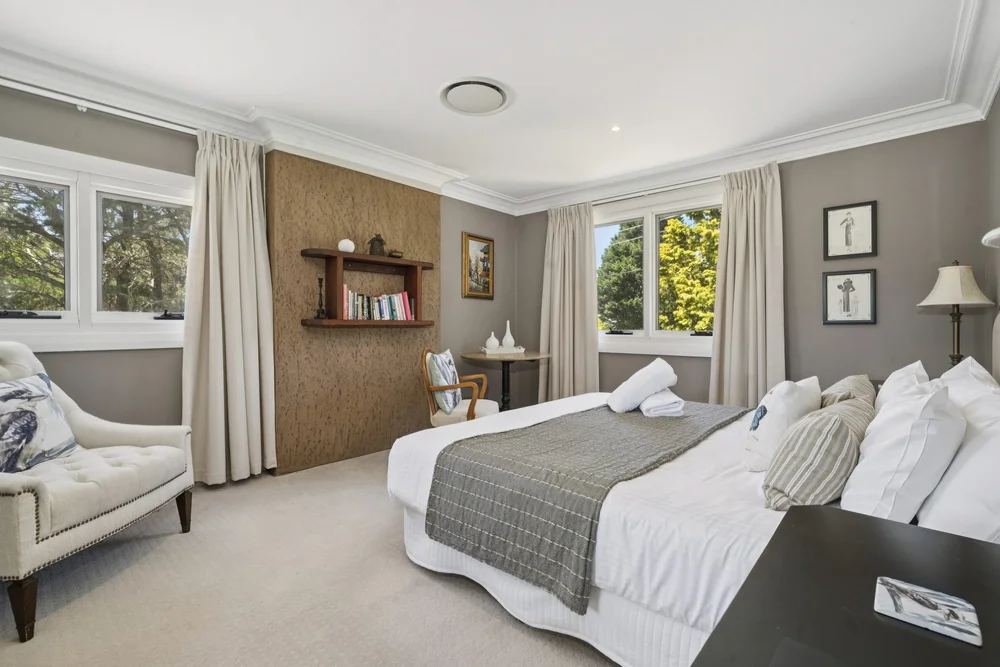 Bedroom 3 with a king bed and a timber feature wall