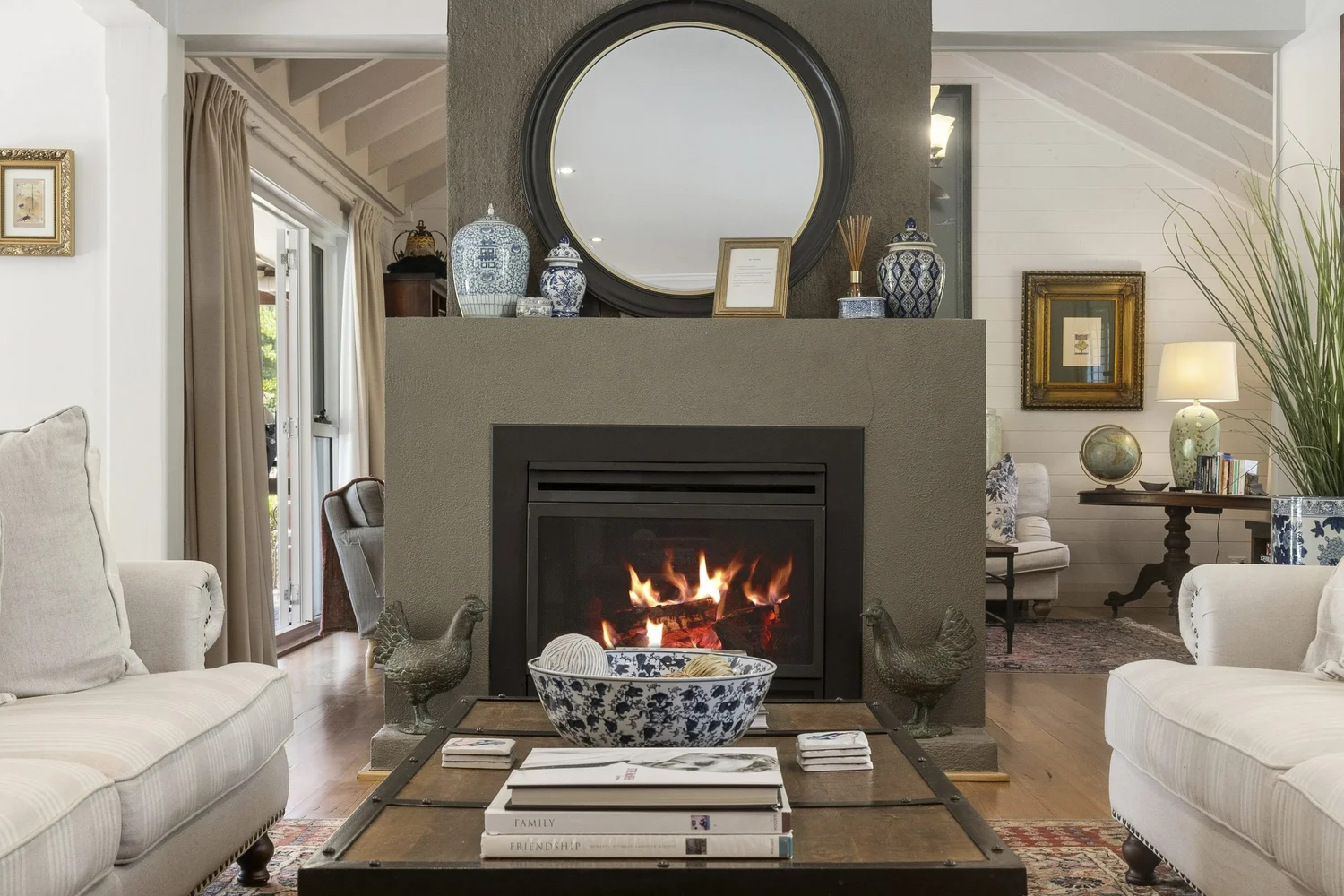 Gas fireplace with a round mirror above in the lounge at Stonelinks