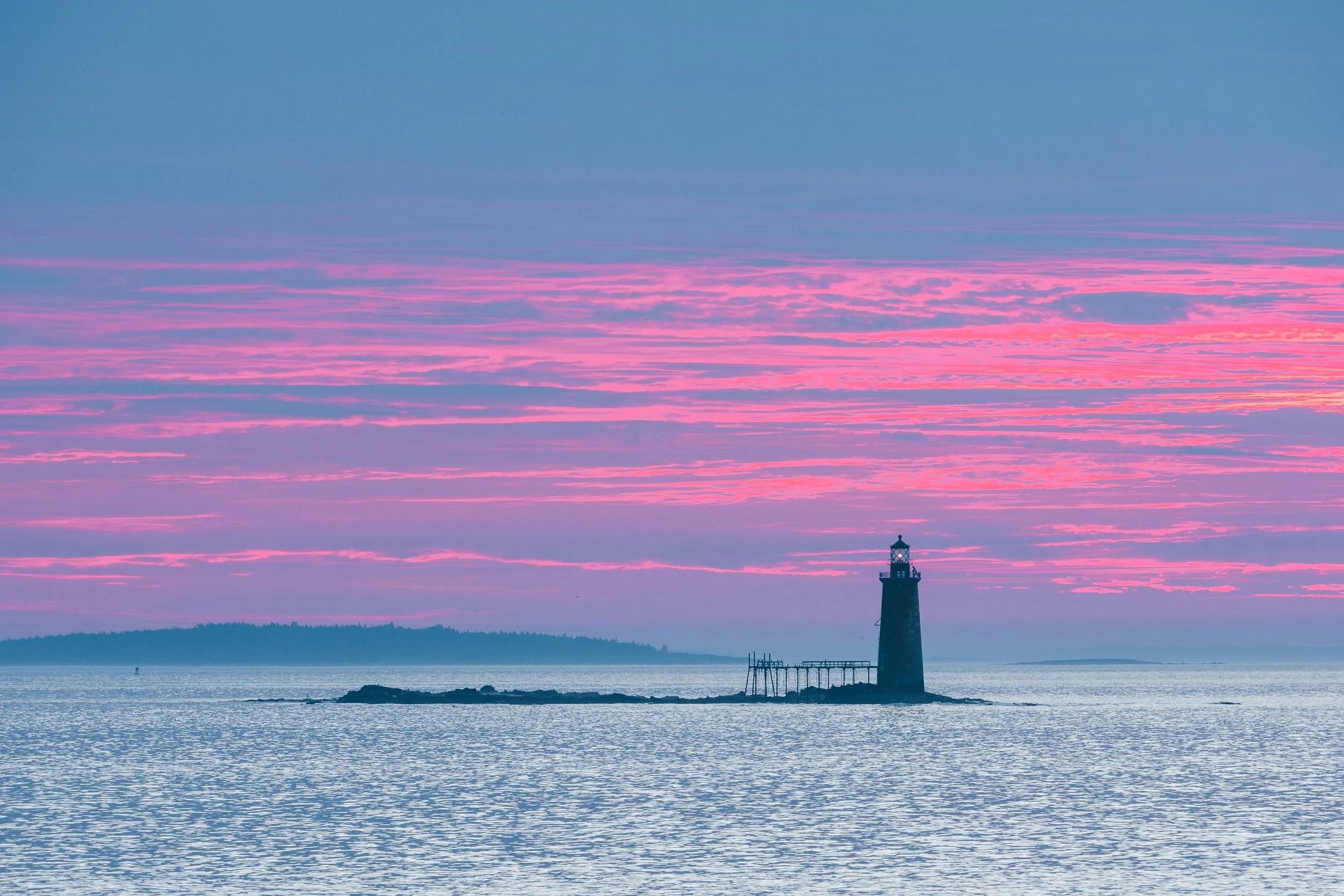 Sunrise view a light from Fort Williams Park in Portland, ME.