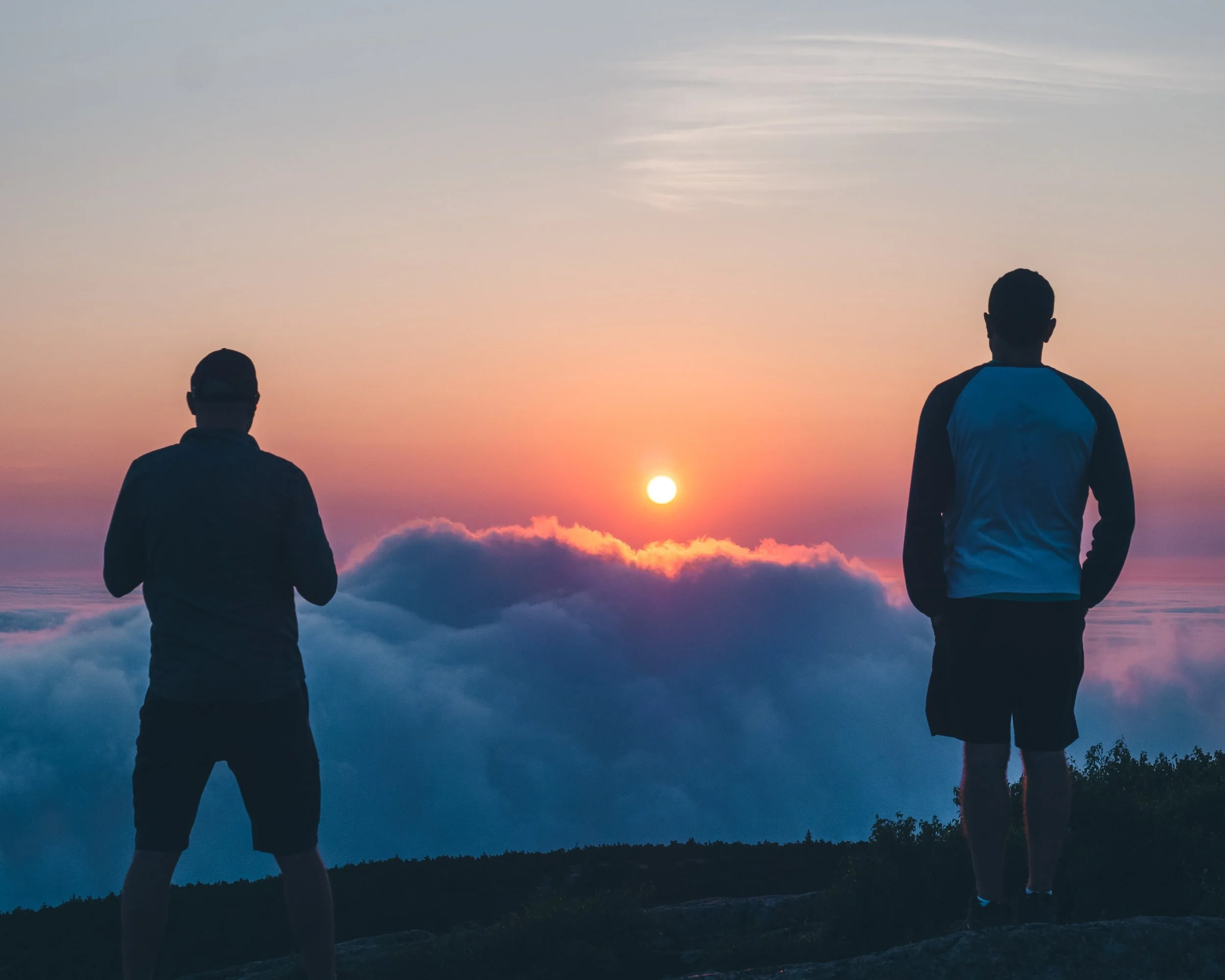 Luis and Vini watch the sun peek above the clouds.