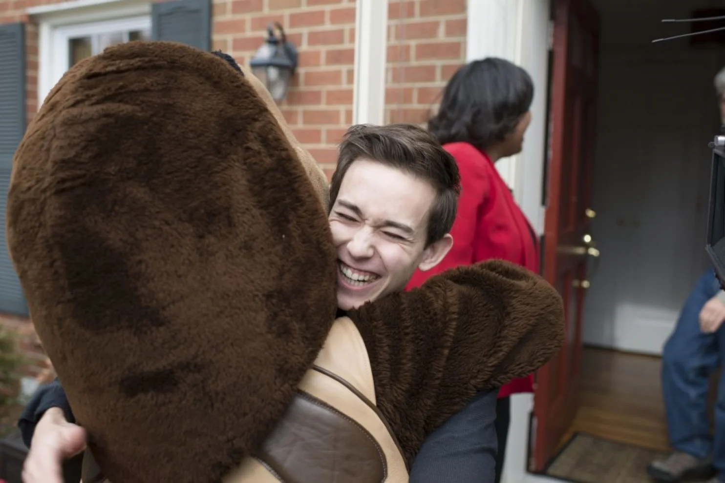 Just look at their faces: A bus full of UMd admissions staff and a turtle mascot surprise applicants with good news