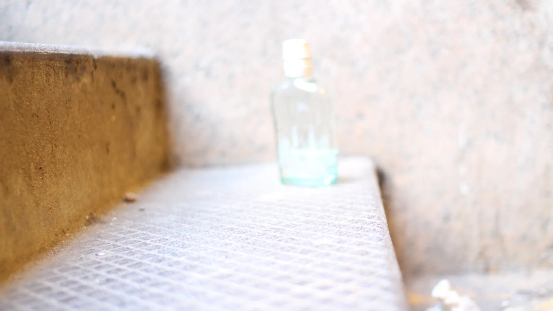  Empty liquor bottle left on the stairs    