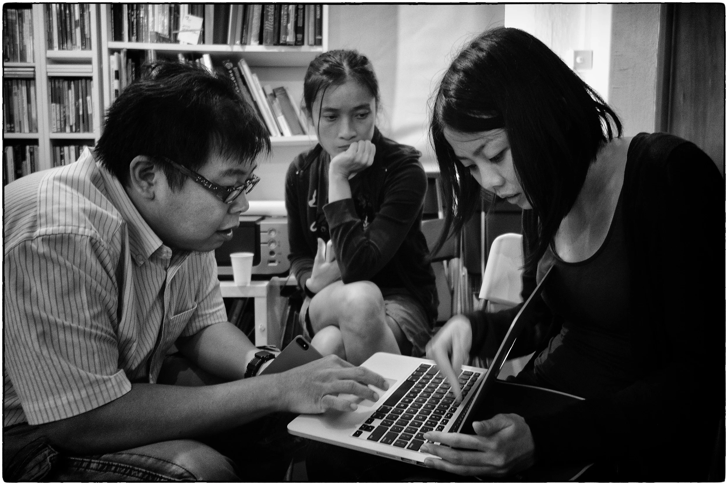 Cheryl (on the right) gets an edit from Darren and Wei Leng.
