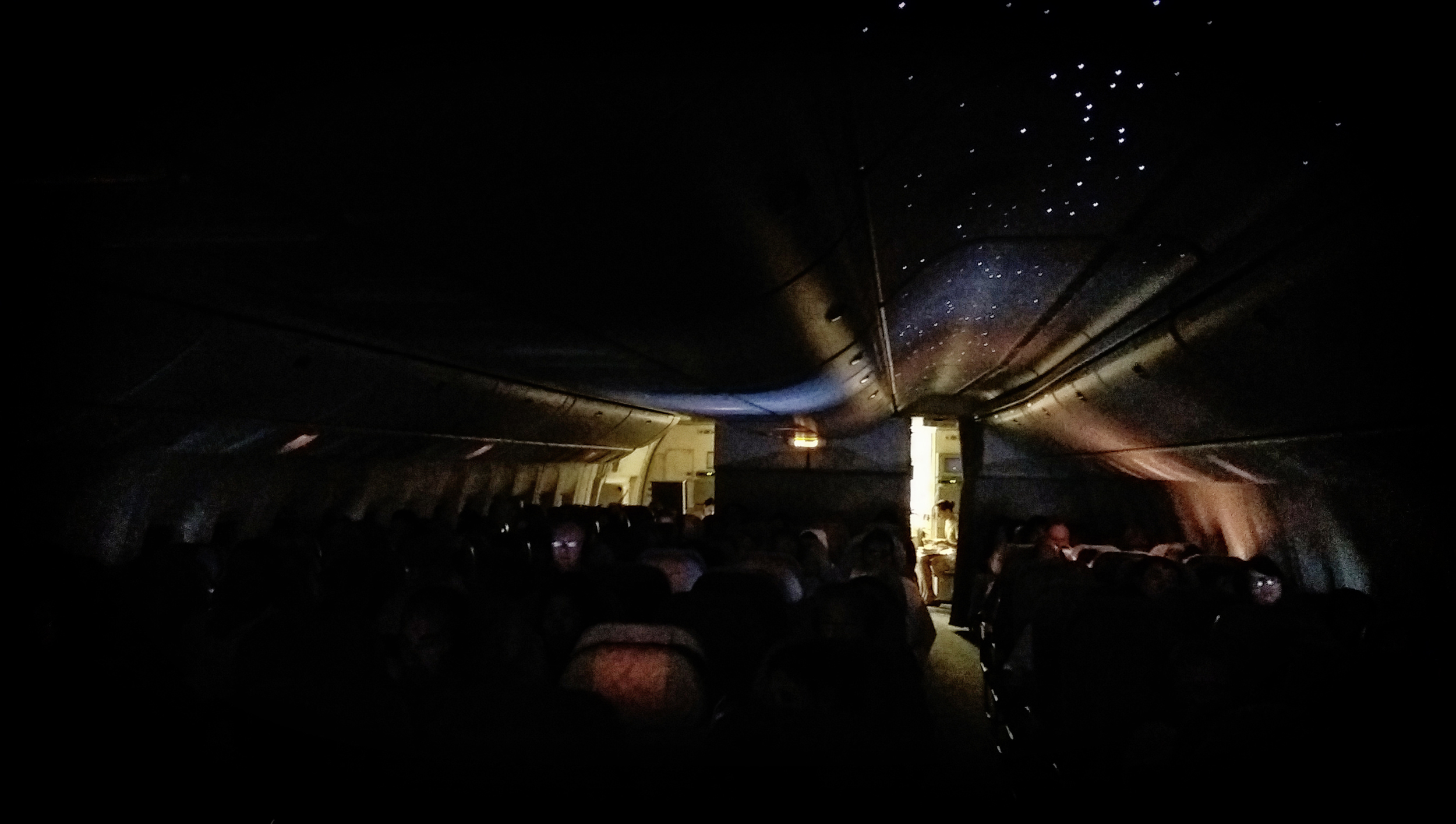 Dinner for one. Even the dimmed interior of an airplane was photographable.