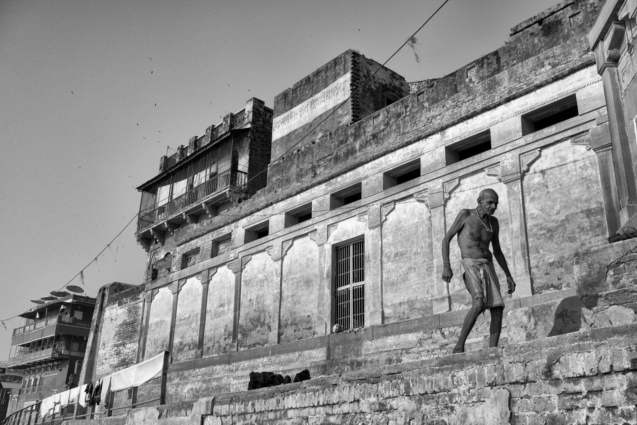 Man Walking Along Ghat Framed Against Wall in Black and White - Varanasi, India - Copyright 2016 Ralph Velasco.jpg
