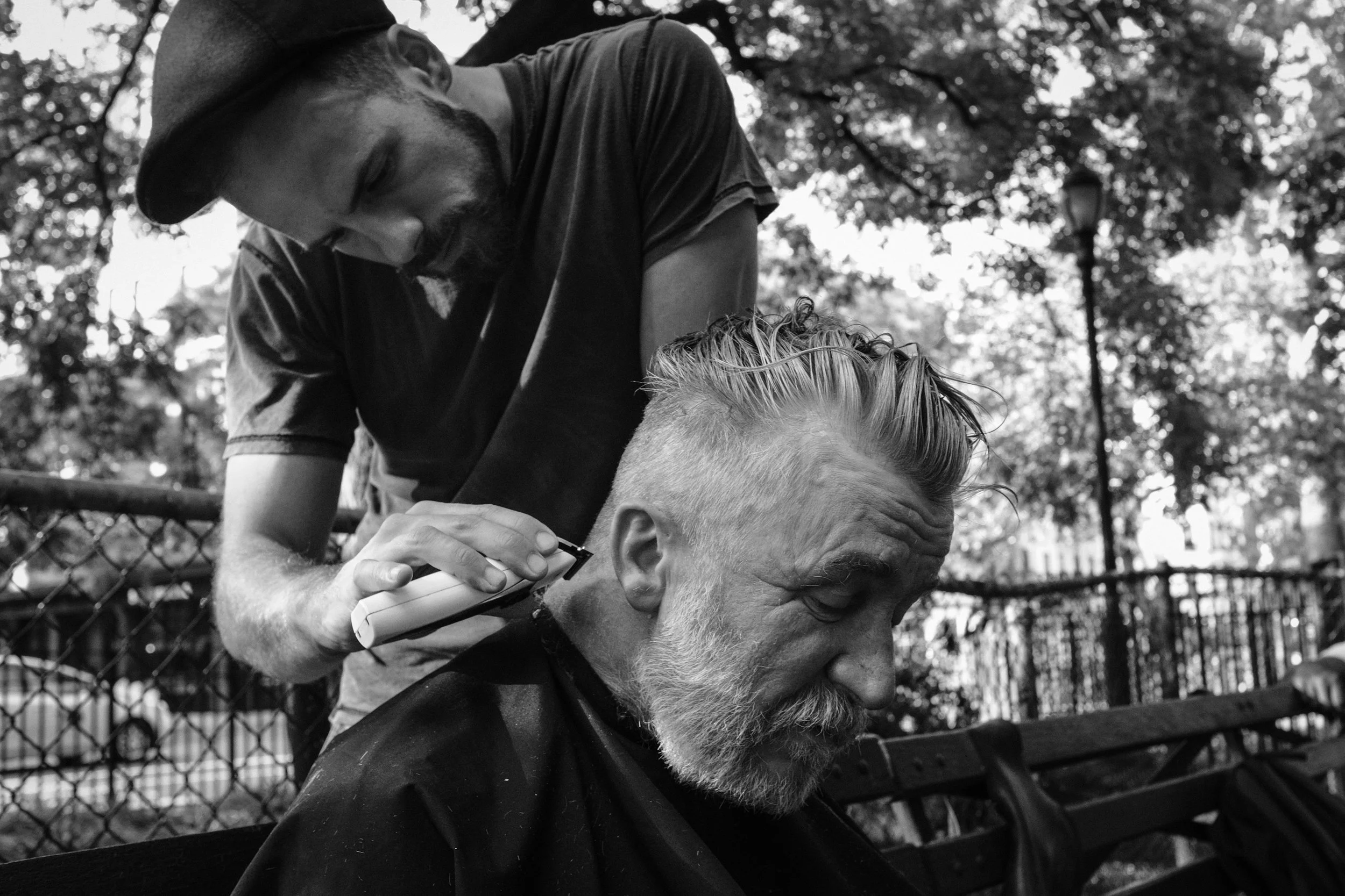 NYC: Janusz is telling his story while Josh is listening and giving him a new look. Janusz left the park with a new spark in his eyes and a spring in his step! See all the NYC photographs in this gallery .