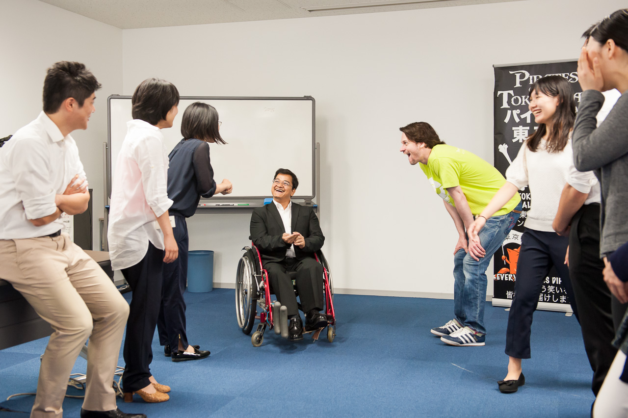 Students laughing during a warm-up exercise at a Tokyo improv comedy class run by Pirates of Tokyo Bay