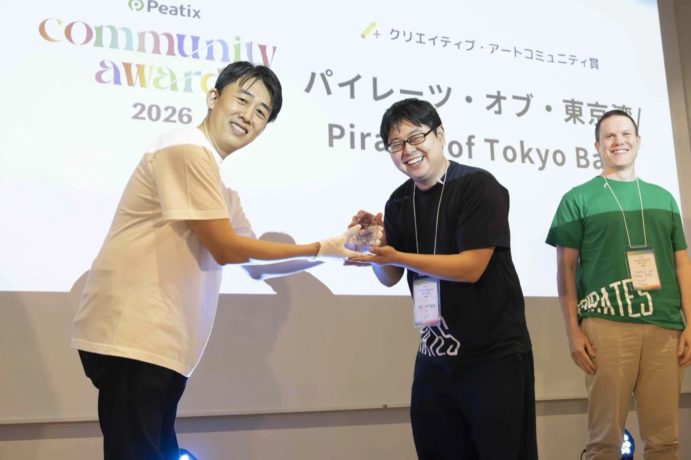 Presenter handing over the crystal trophy to the Pirates of Tokyo Bay