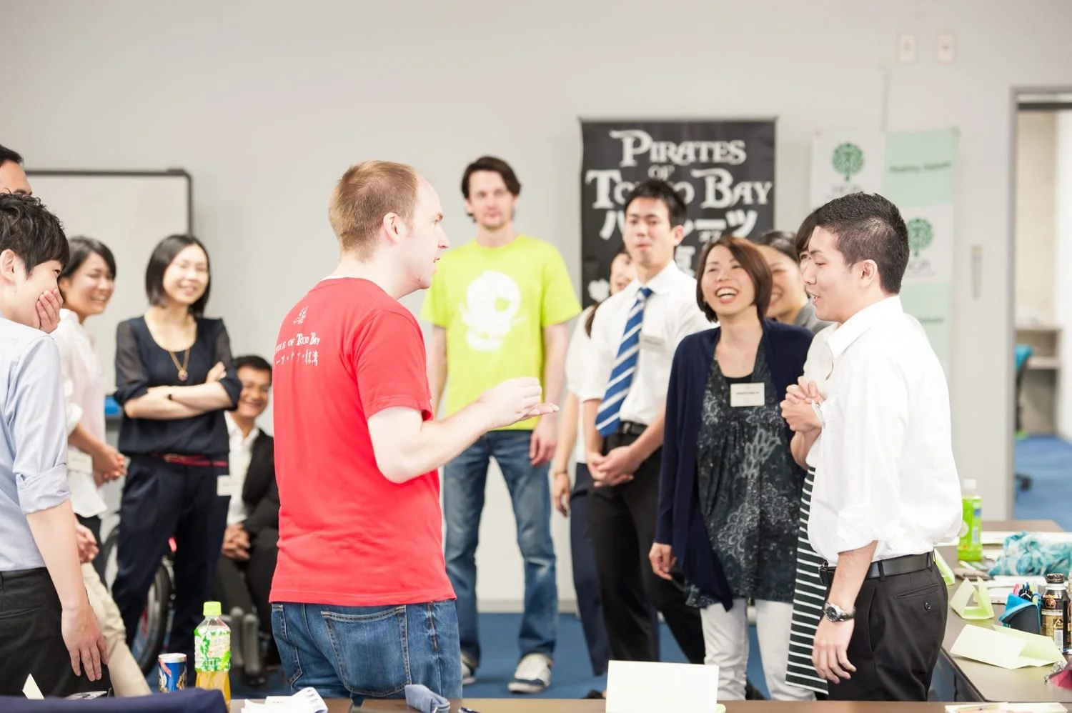 Improv performers leading a team game with office staff at a company event in Tokyo | 忘年会 余興 即興ゲーム 社内イベント 東京 | Pirates of Tokyo Bay