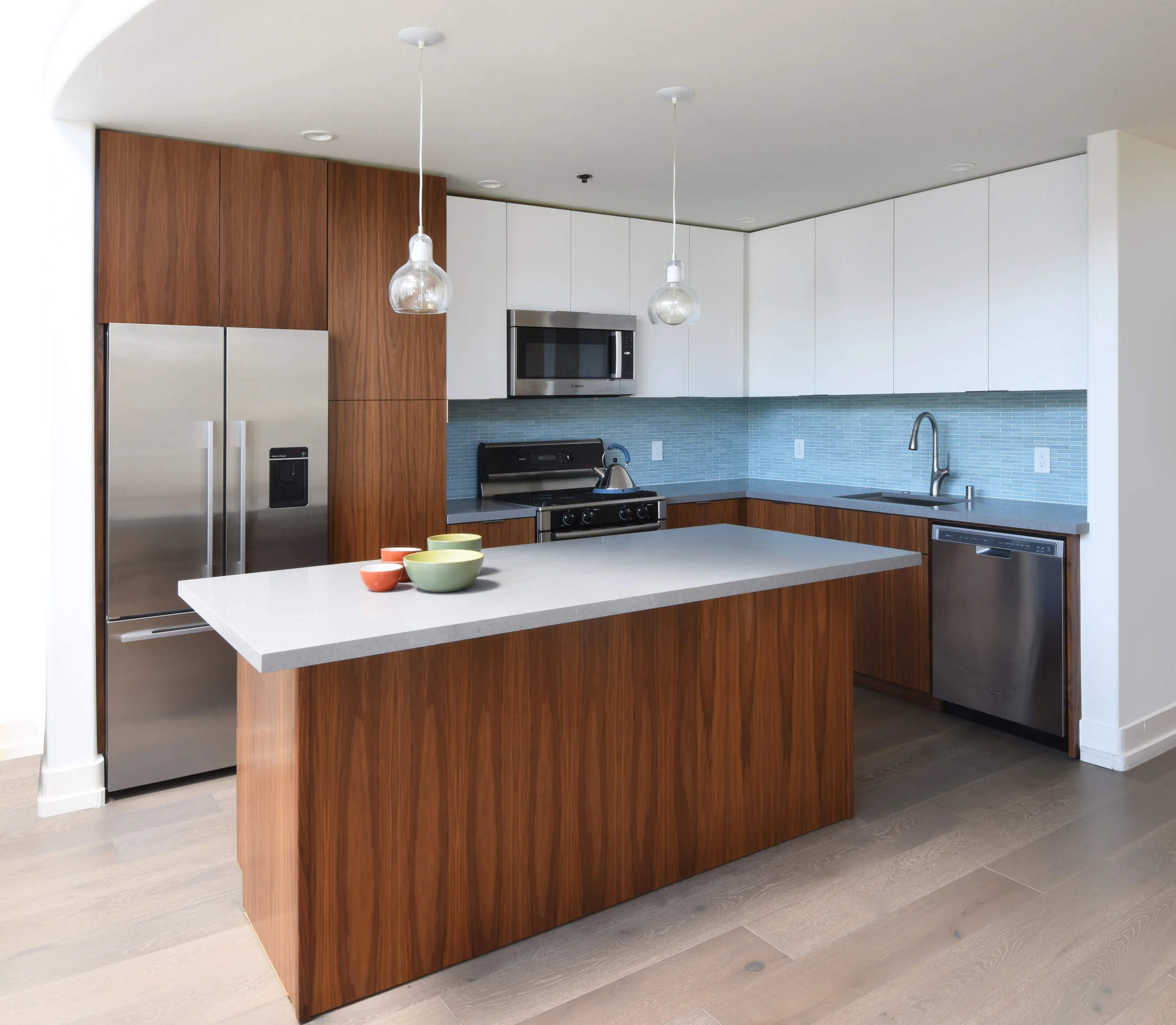      cookies + cream    The kitchen of this cool San Francisco loft received a make-over by introducing wood-and-laminate cabinets, stainless steel appliances and quartz counters. To accommodate the special requirements of my clients, a pantry and se
