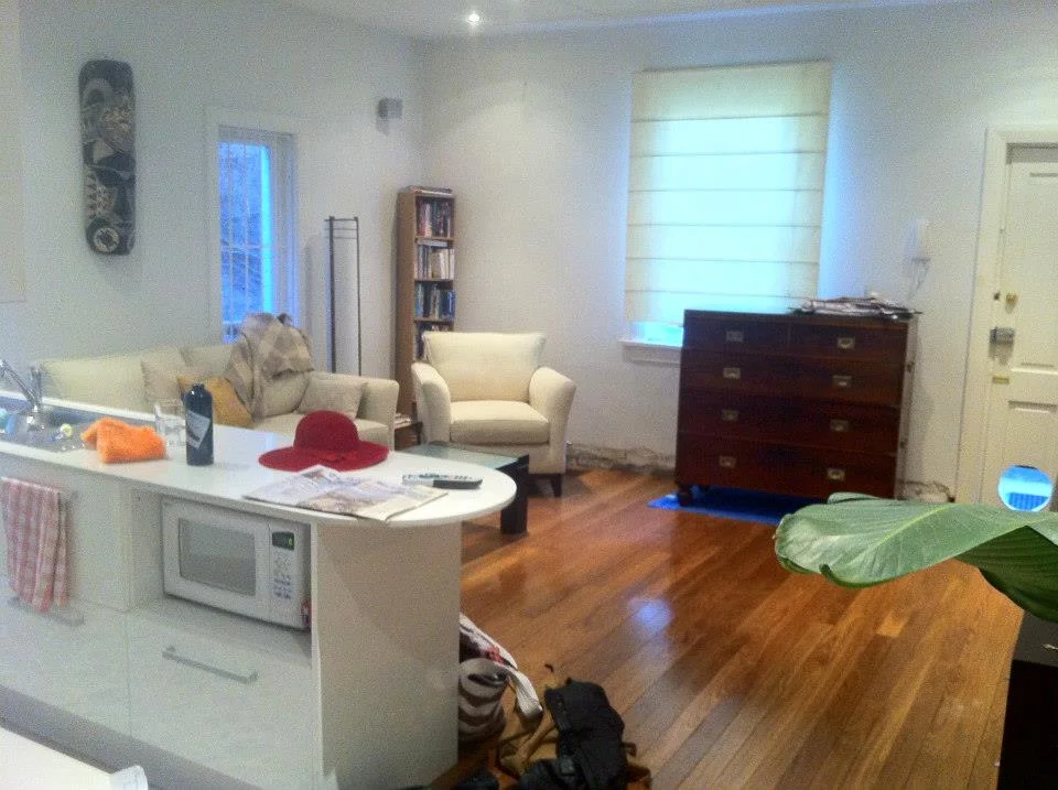 Before view of an unused living space with clutter. A lot of potential, beautiful furniture. 