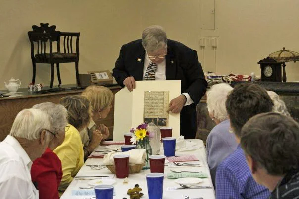 Scott talks to dinner attendees about this page from an ancient middle-eastern book.