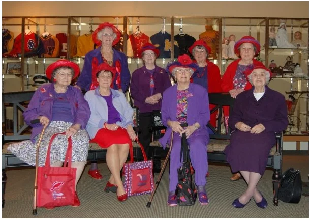 A group of Red Hatters pause during their tour of the museum's gallery.