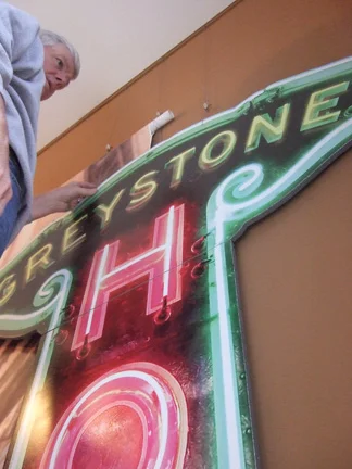 Jim Buher takes down the sign after the exhibit is over.