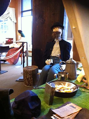 Camp scene using re-enactment clothing and equipment, Girlfriend Annie Rogers' home scene can be seen in the background.
