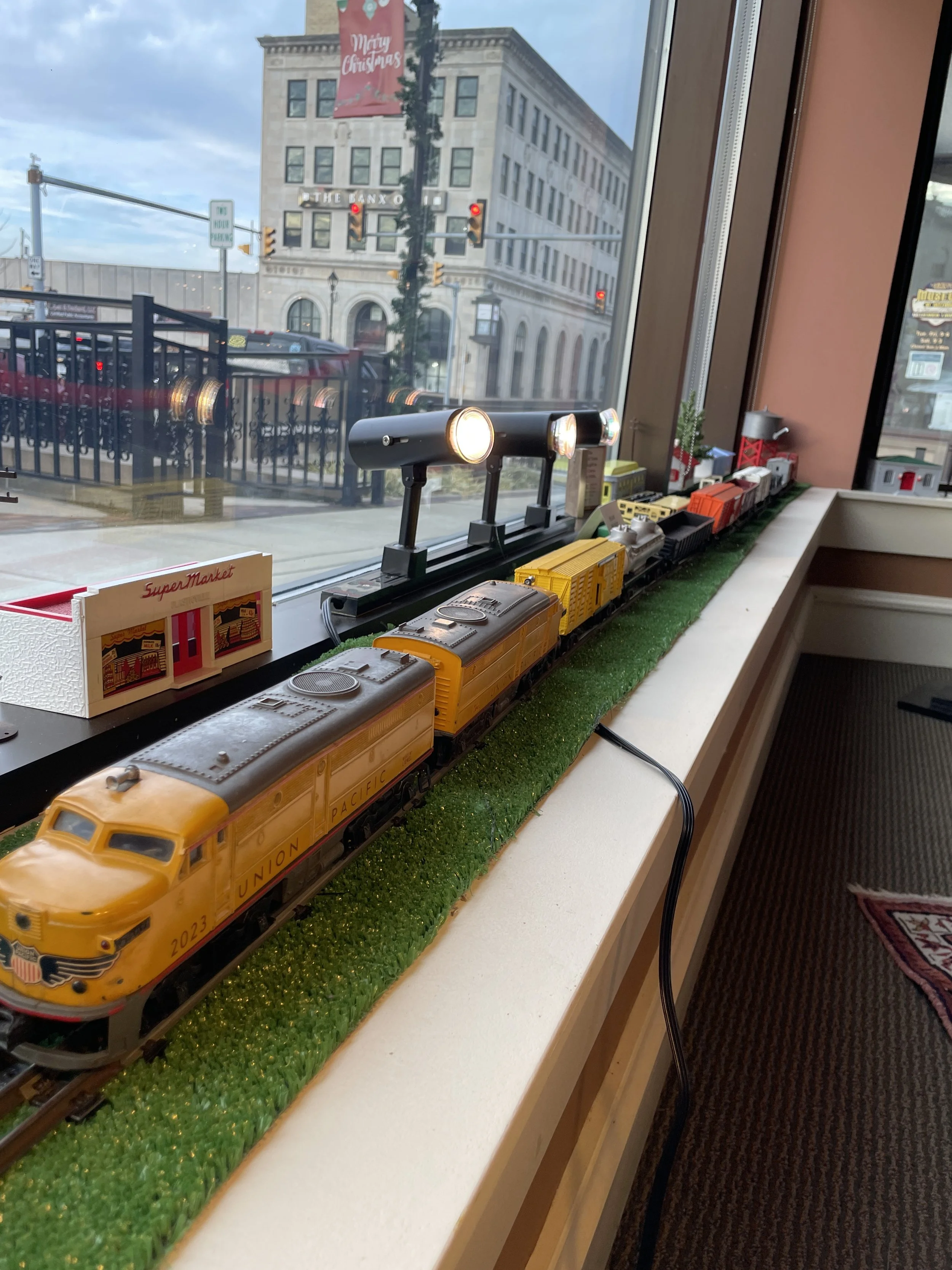  A few of Billie Corya's 1950s Lionel train and model buildings in the front window. 